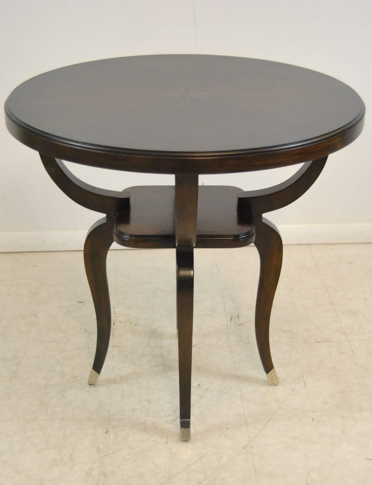 An unusual round end table by Robb & Stucky. This is the Parisian end table which is 29