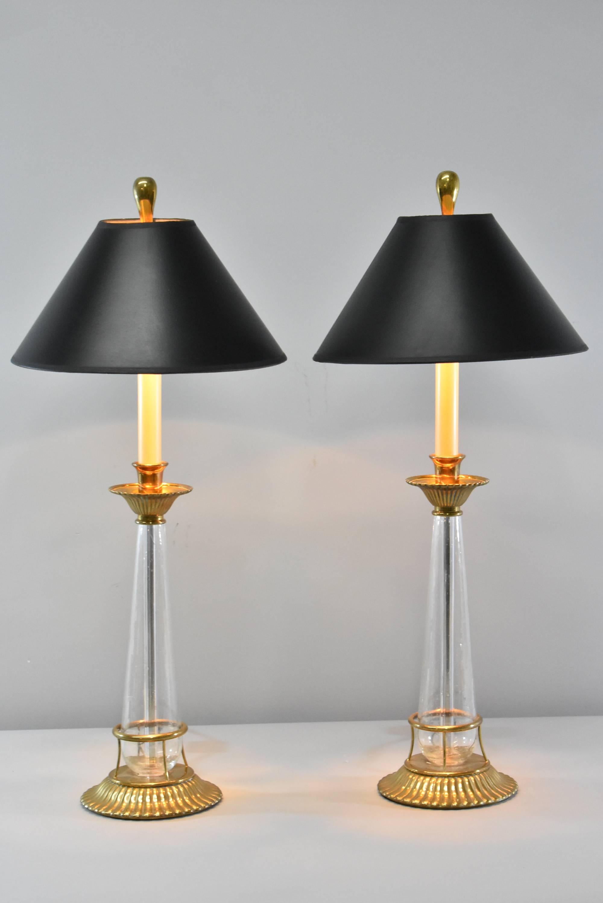 A beautiful pair of brass and glass buffet lamps by Chapman. They feature tapered glass bodies, brass boboches, a fluted design base, faux candle motif and brass inverted teardrop shape finials. Very good condition with good wiring and a two way