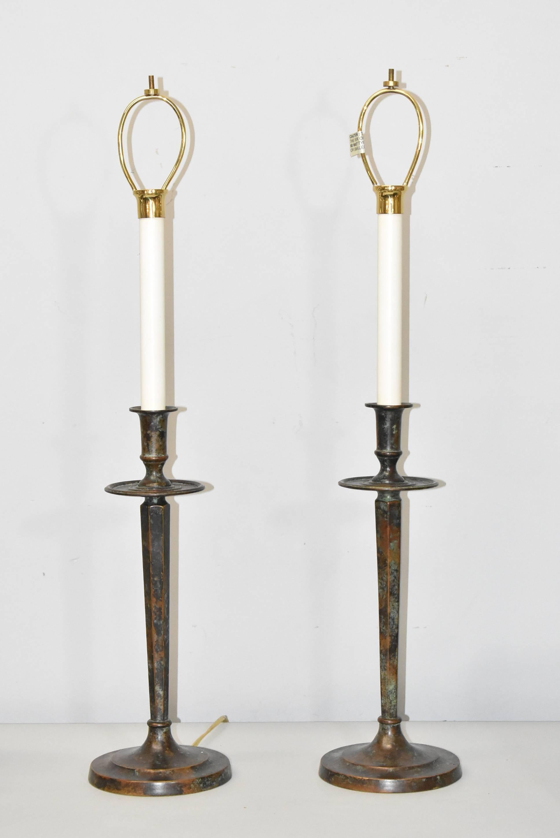 A fantastic pair of buffet lamps by Maitland-Smith. These beautiful lamps feature a verdigris copper finish and handmade interwoven oxidized copper shades with a single candelabra size socket. Simple elegance that would be perfect for any buffet,