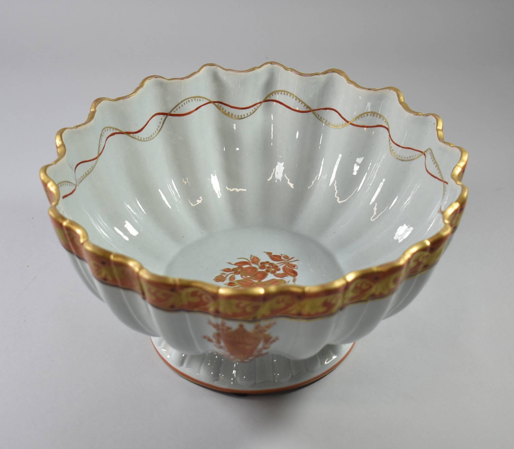 A magnificent Italian bowl by Mottahedeh. This beautiful footed bowl features a scalloped edge with an urn detail in shades of orange and gold. Mottahedeh did custom work for many high end jewellery stores and was known for supplying the White