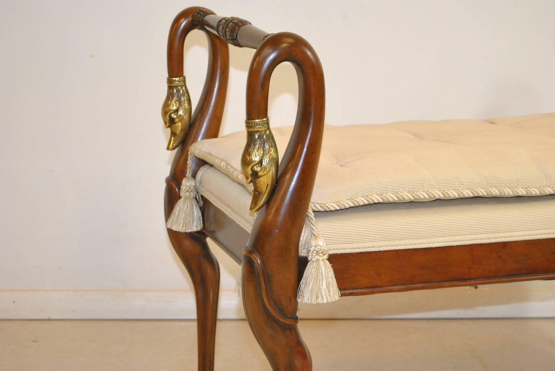 The bench with swan neck from the American manufacturer Baker Furniture. The frame is made from wood French cherry. The seat has a very pleasant tufted upholstery that is in excellent condition. The model is handmade with carved legs and armrests.