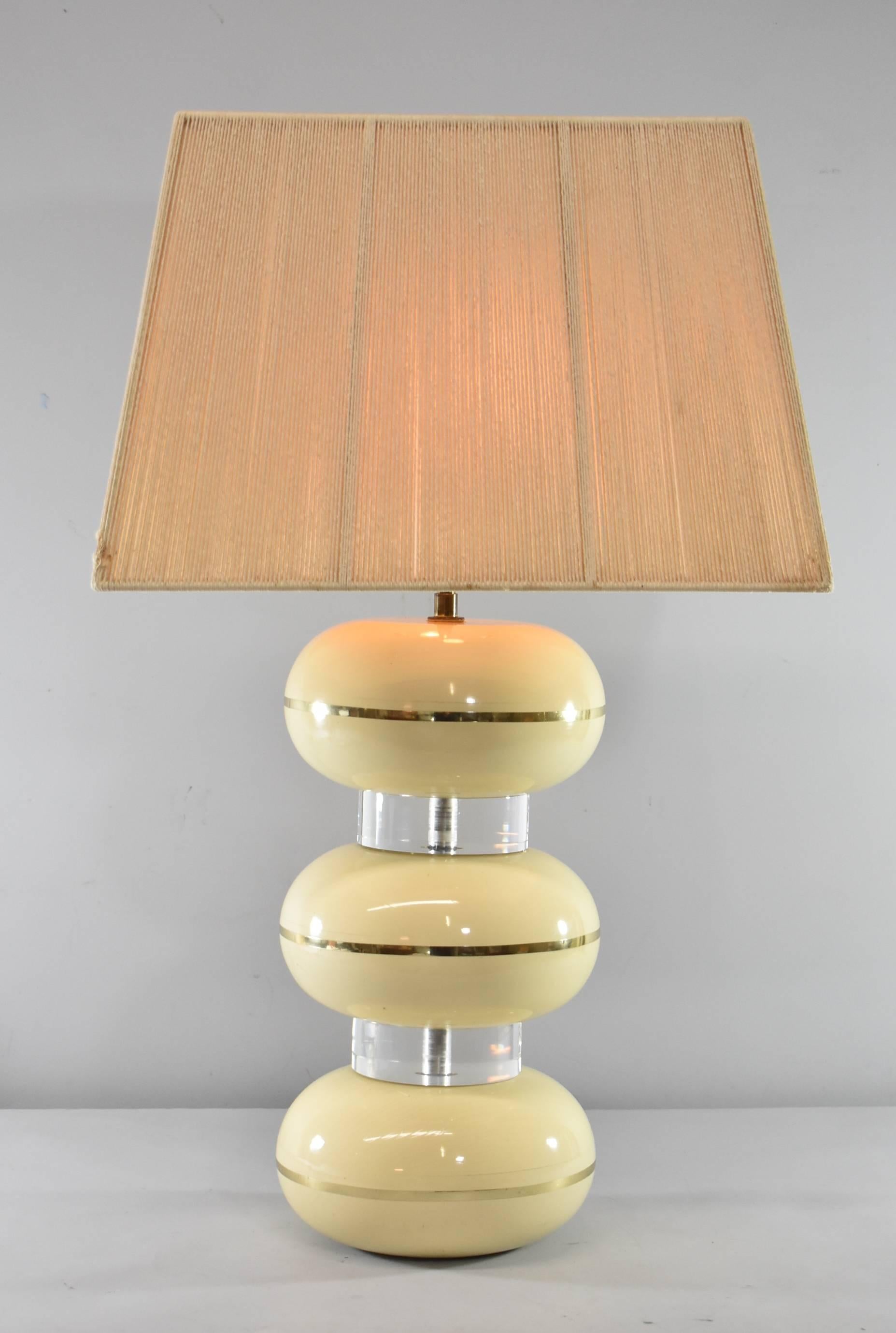 A fantastic table lamp by Karl Springer. This great lamp features three round plaster compressed spheres separated by two Lucite spacers. It has a two light cluster socket with Springer's Coffin pull chains. Original string shade. We have two