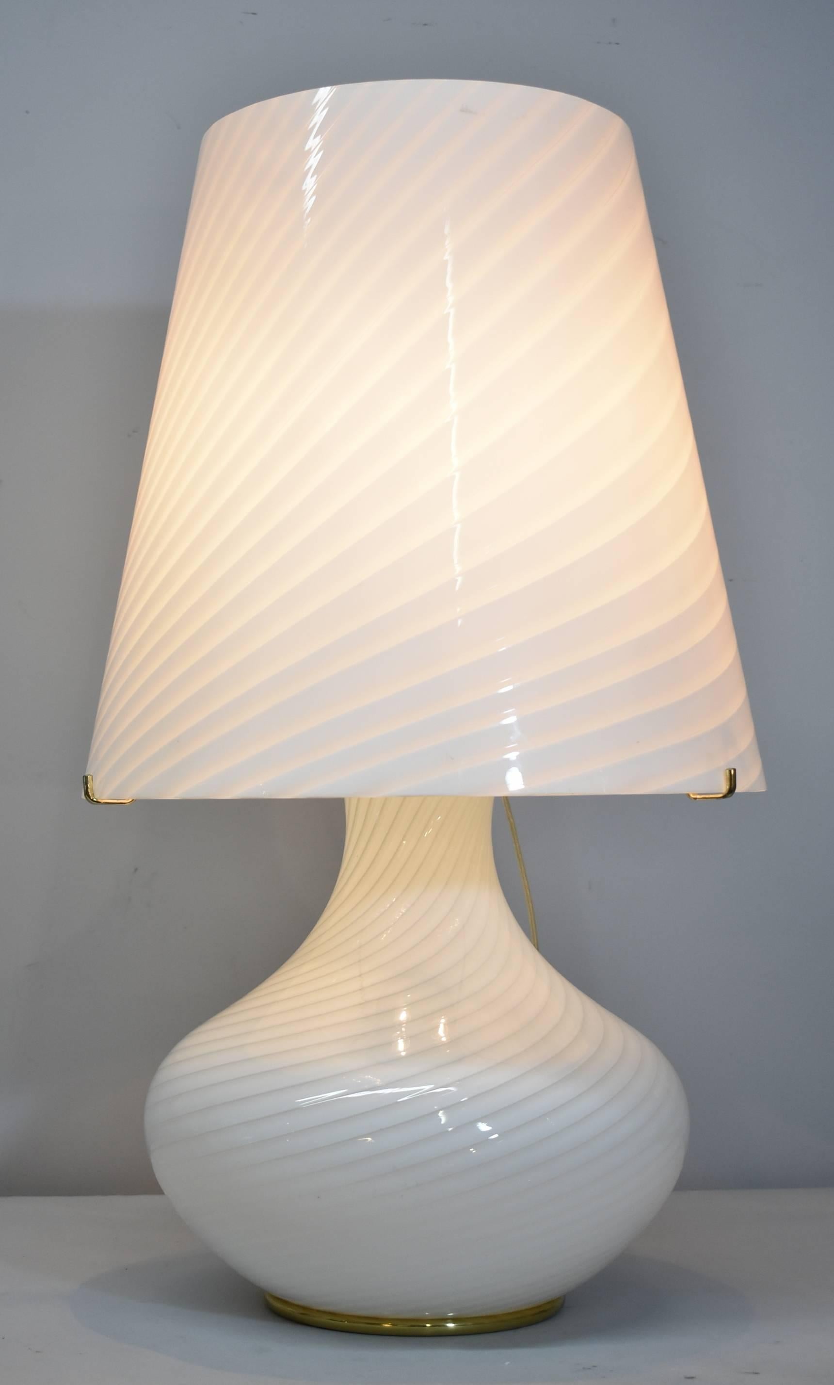 Unusually large Venetian glass table lamp by Vetri Murano. Murano glass is done in an unique swirled pattern. Lamp has brass fittings with three cluster socket. Switch has multi-level settings. Dimensions are 29