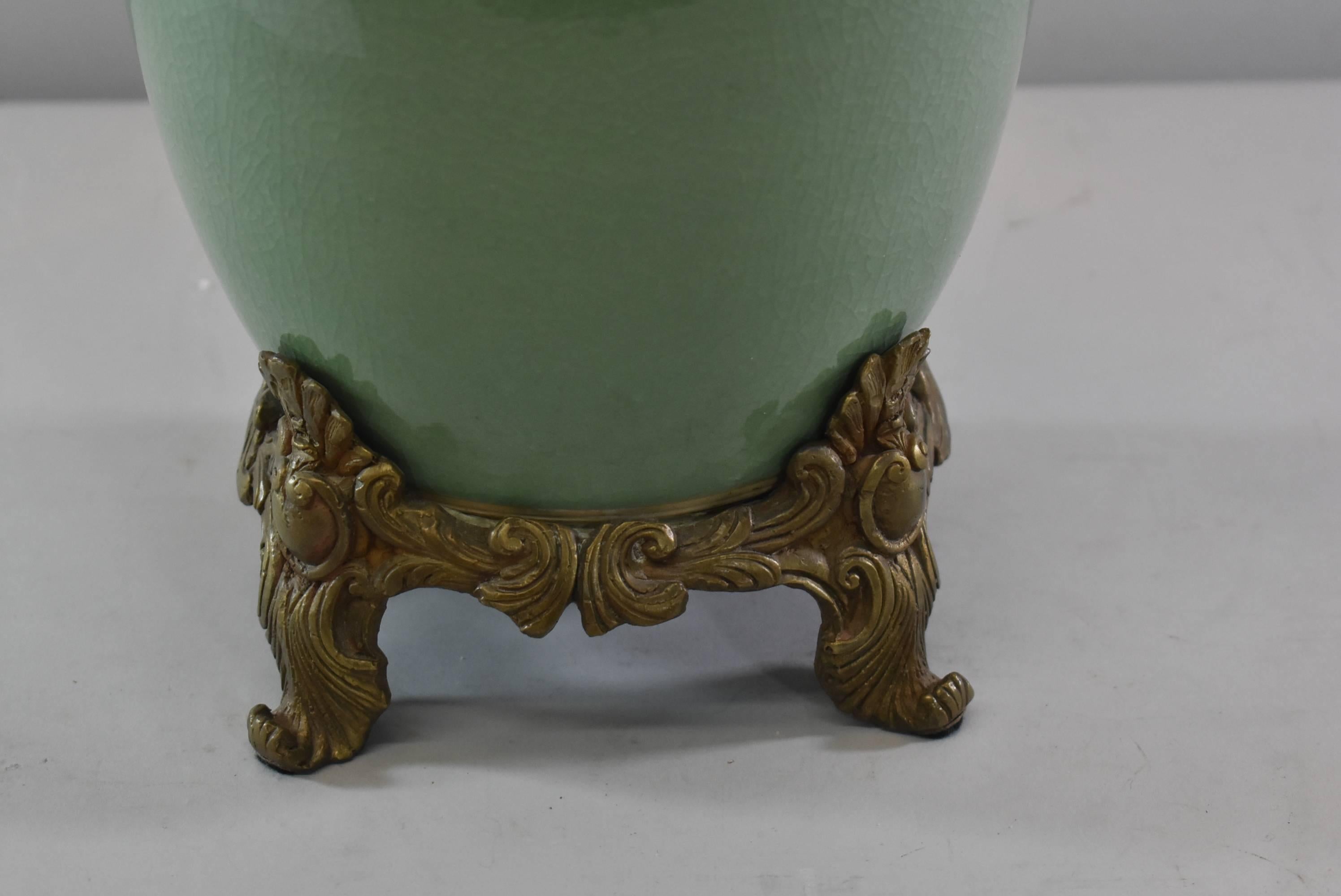 Asian Style celedon green porcelain and bronze single socket table lamp. Decorative ornate base in bronze with two applied handles on the side.