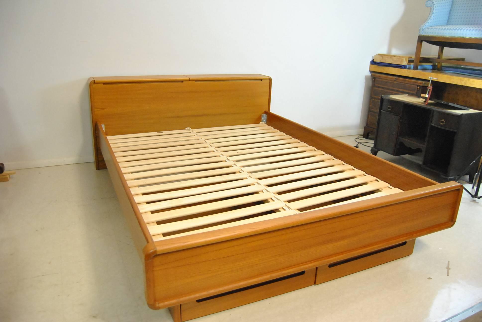 A sleek and stylish midcentury teak queen-size bed by Sun Cabinet and nightstand. This great set features a lift top headboard for storage and two additional storage drawers. Perfect for you modern decor. The dimensions are 91