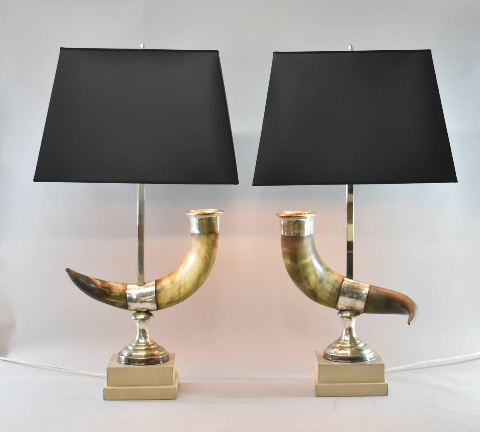 A unique pair of long horn steer table lamps.  These awesome lamps feature a chrome base with a leather wrapped bottom and 3 sockets.  The horns are cast from natural steer long horns.  Unusual, they will be a perfect match for your rustic decor. 