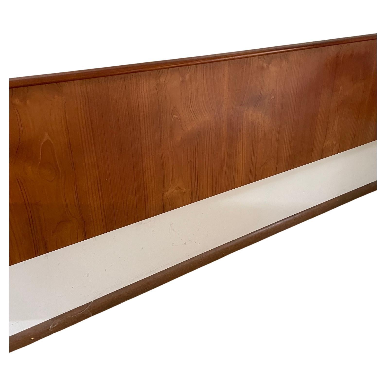Mid Century Modern teak king size wall mounted headboard with two mounted stands. Each stand has a drawer with carved handle. Very good condition. Dimensions: 2