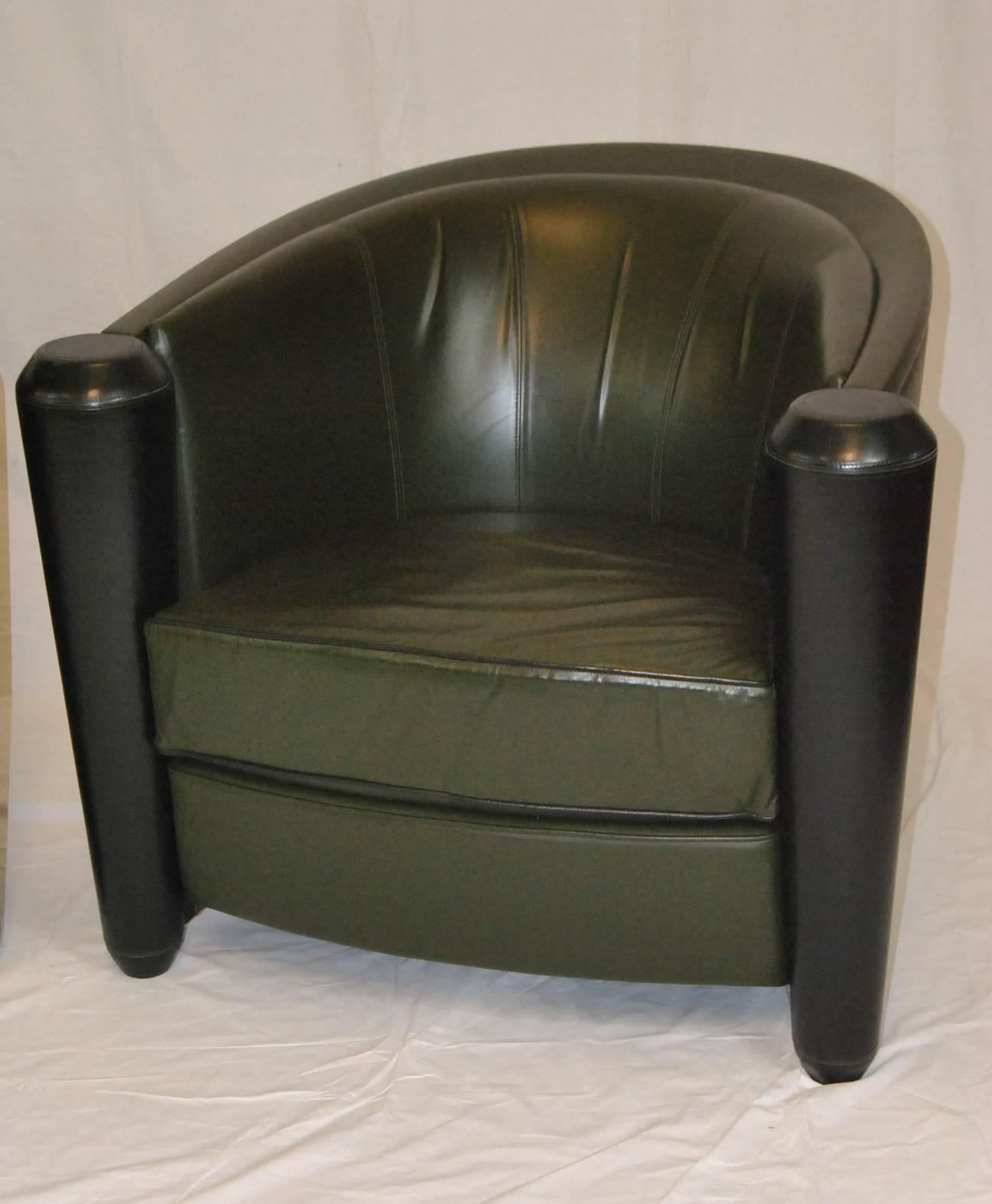 A beautiful pair of Italian leather club chairs designed by Adam Tihany for the Pace Collection.  The chairs are in dark olive green with black accents.  Manufactured by I4 Mariani.  Circa 1990's.