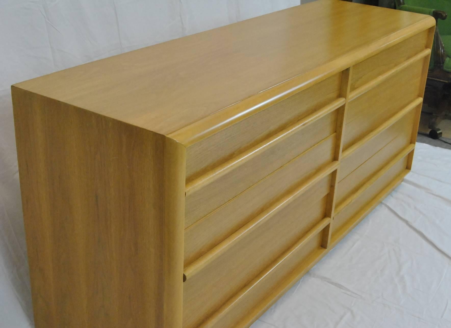 A great Mid-Century Modern six drawer dresser designed by T.H. Robsjohn-Gibbings for the Widdicomb Furniture Company.  The top two drawers have removeable dividers.  Clean lines and great patina.  Dresser may have an old refinish but, if so, it was