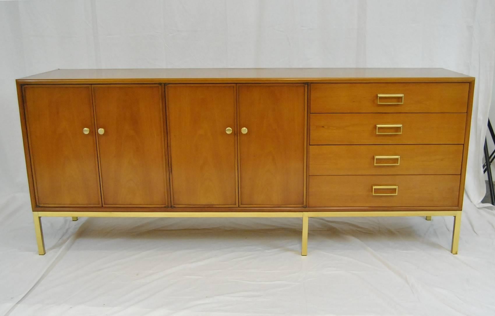 A great Mid-Century credenza by Kipp Stewart for Drexel as part of their Sun Coast collection.  The credenza is done in cherry with four doors and four drawers.  Doors open to two storage areas with one adjustable shelf per area.  There are four