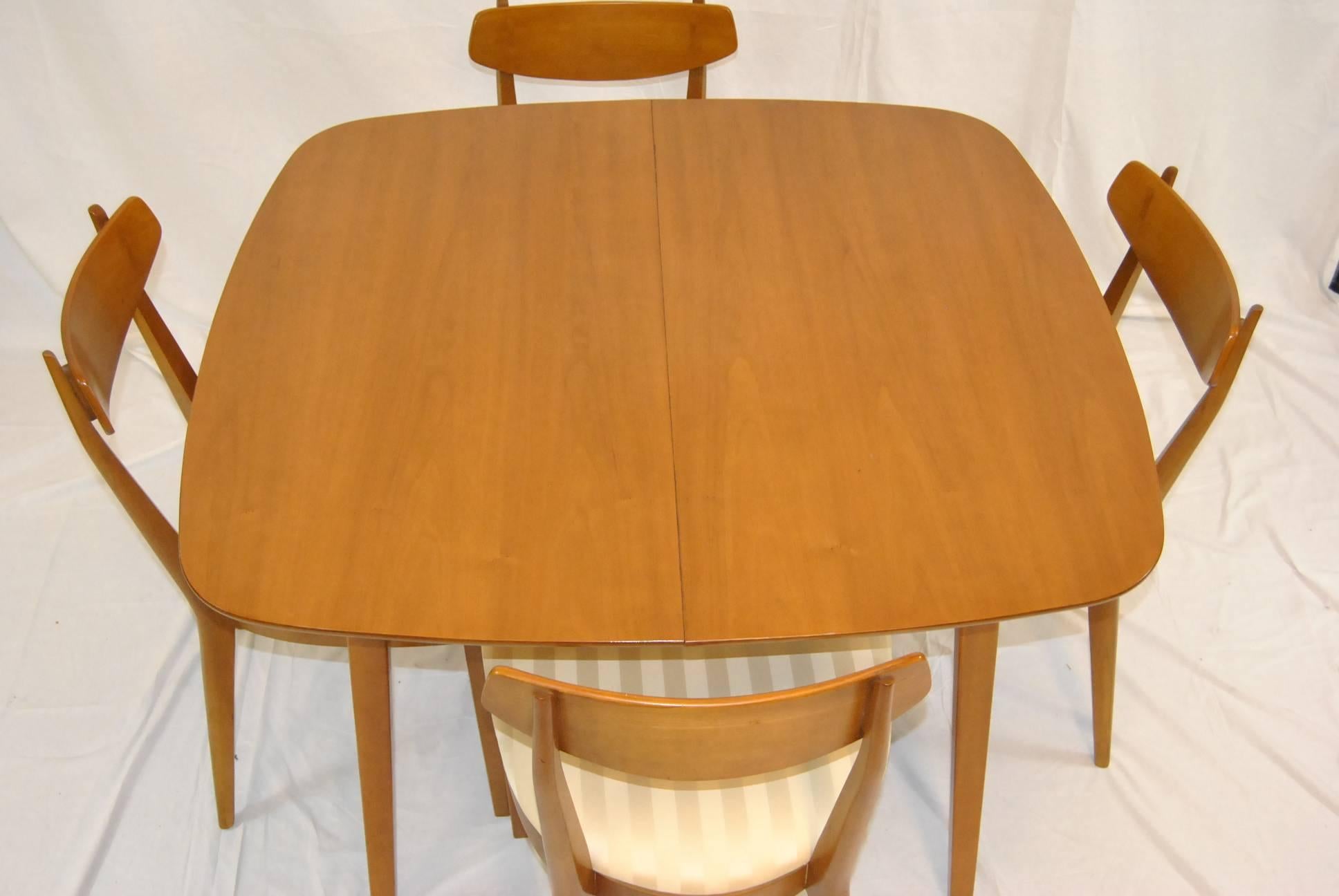 A great Mid-Century Modern dining set in cherry designed by Kipp Stewart for Drexel.  This is the Sun Coast Collection dining set and it includes a 44" square table with two 20" leafs (1 skirted, 1 unskirted) and four side chairs.  Chairs