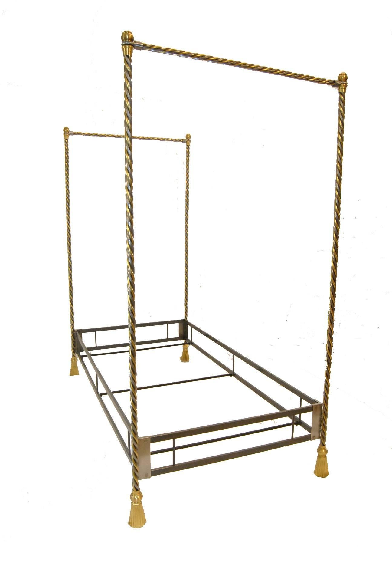 An unusual iron and brass twin canopy bed.  The posts are twisted brass and iron which end in a brass tassel foot.  Bed can be used with and without side canopy frame.  Bolt on rail base is constructed of heavy iron.  The bed is heavy and well