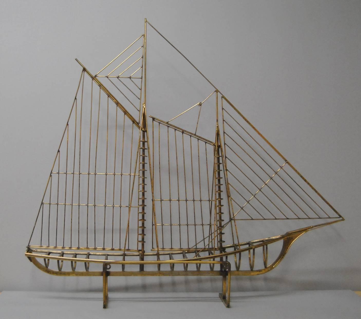 A large brass skeleton of a sailboat by Curtis Jere.  This can be set on a table or mounted on a wall.  Signed Jere 1976. Brass on Steel. 