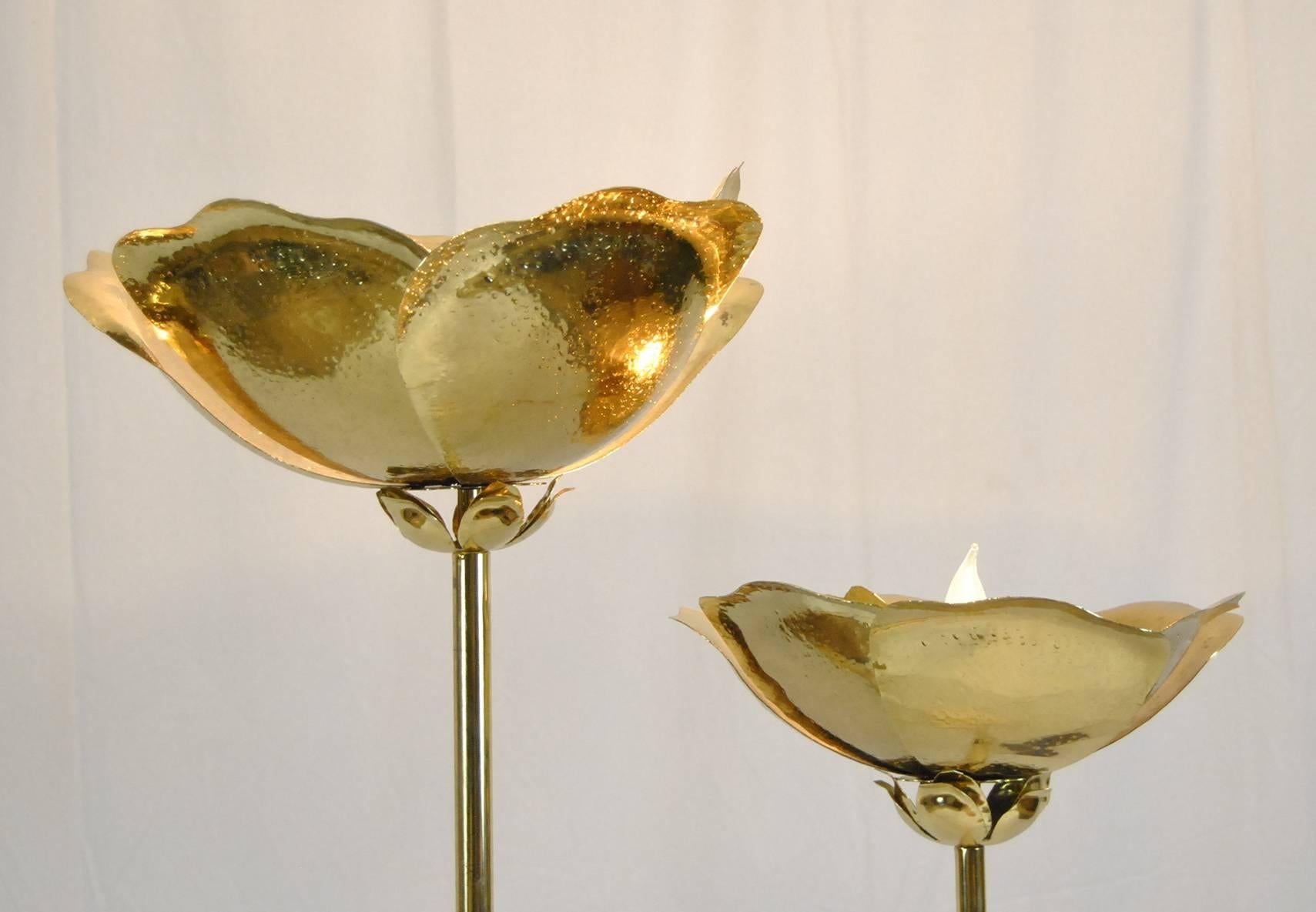 A stunning floor lamp by Tomasso Barbi.  The lamp has two brass stems with hammered brass flowers at the top.  Each flower has a single socket.  The base is travertine.  A great accent piece for your room.