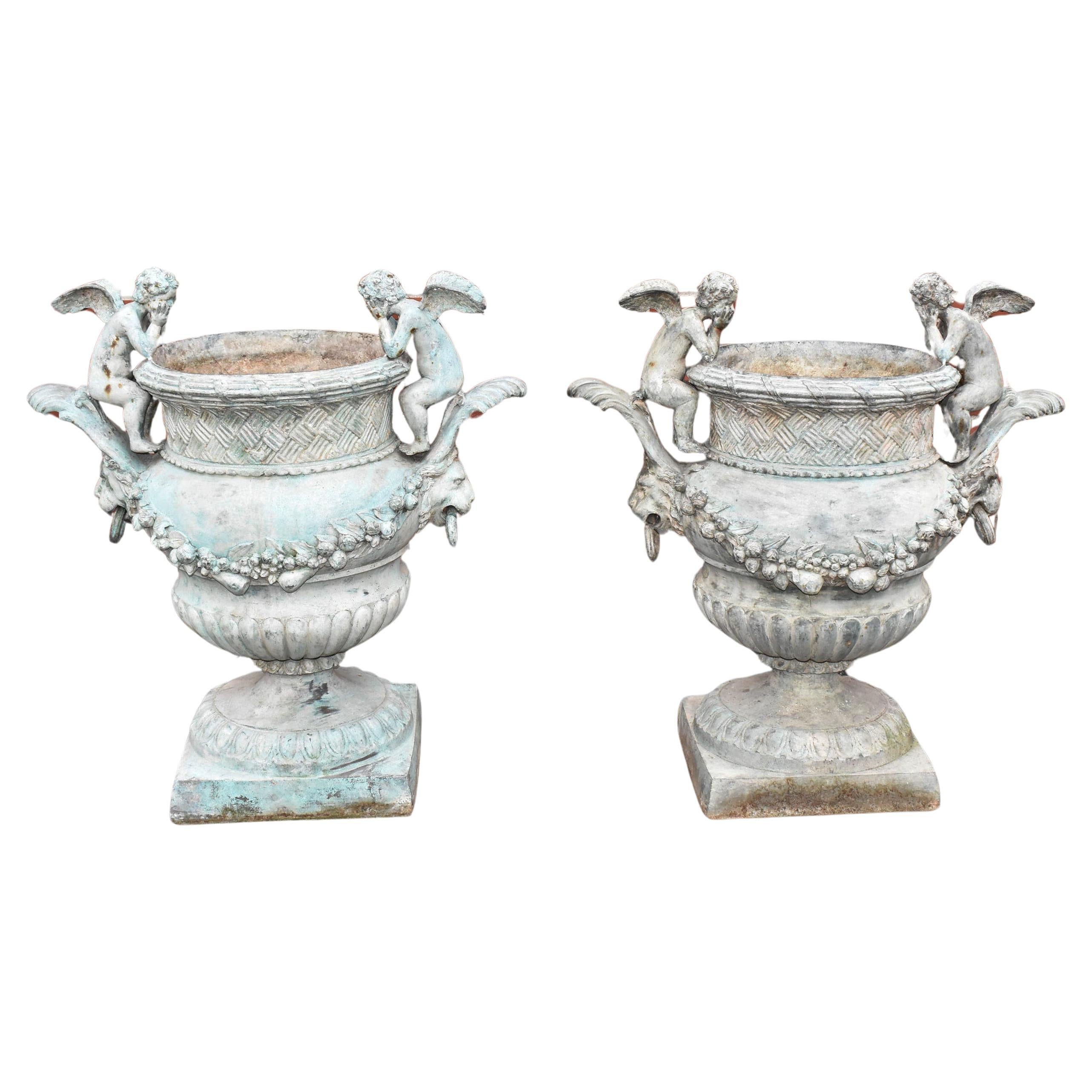 Pair of Bronze Outdoor Urns with Winged Cherubs