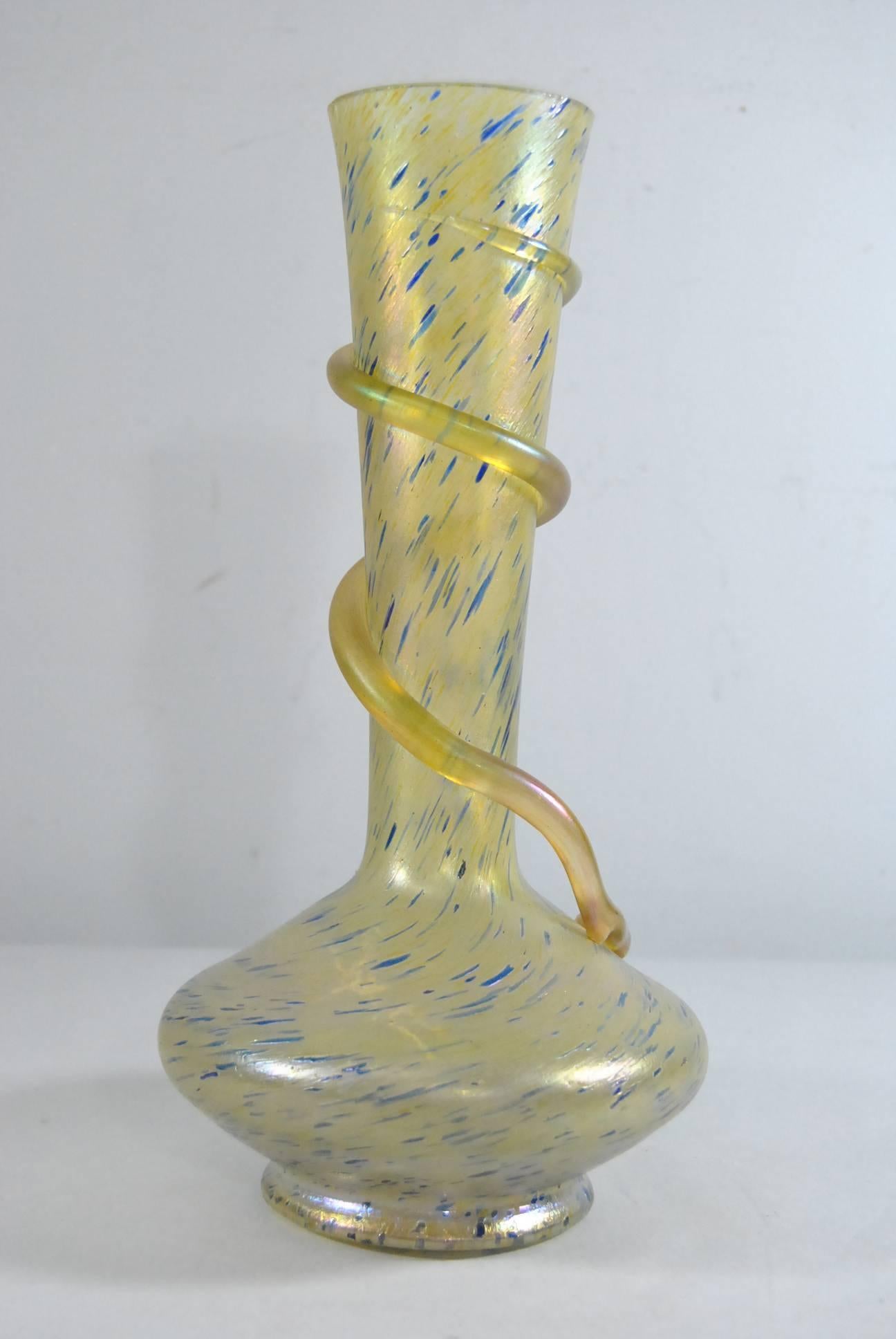 Style of Loetz art glass snake vase. Overall subtle iridescence in amber with flecks of blue. Unsigned but believed to be Loetz.