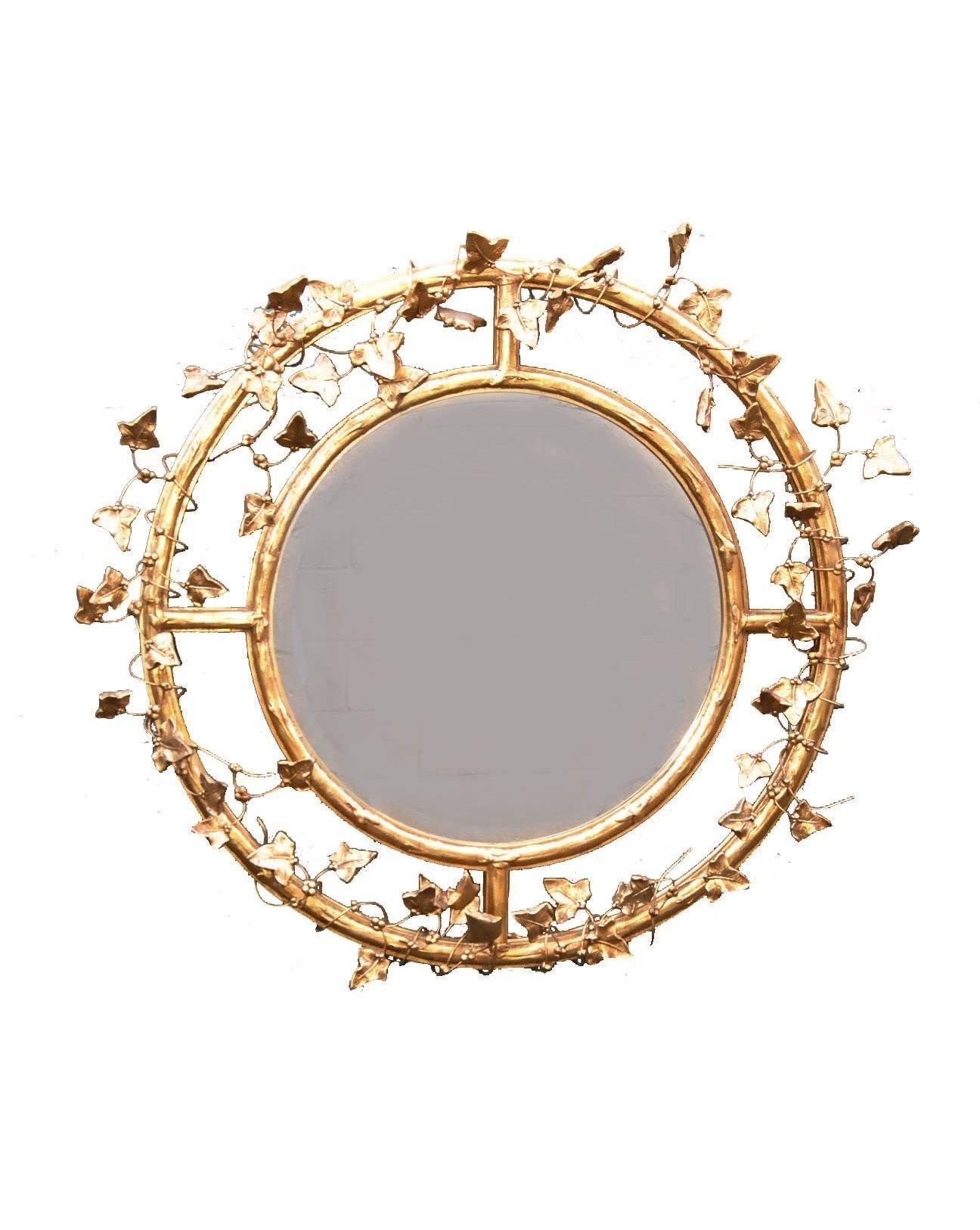 A fine pair of round beveled mirrors handcrafted by Friedman Brothers. They feature a double circle that is wrapped in delicate gold leaves and vines. Their impressive size and stunning design will easily add character to any room where they are