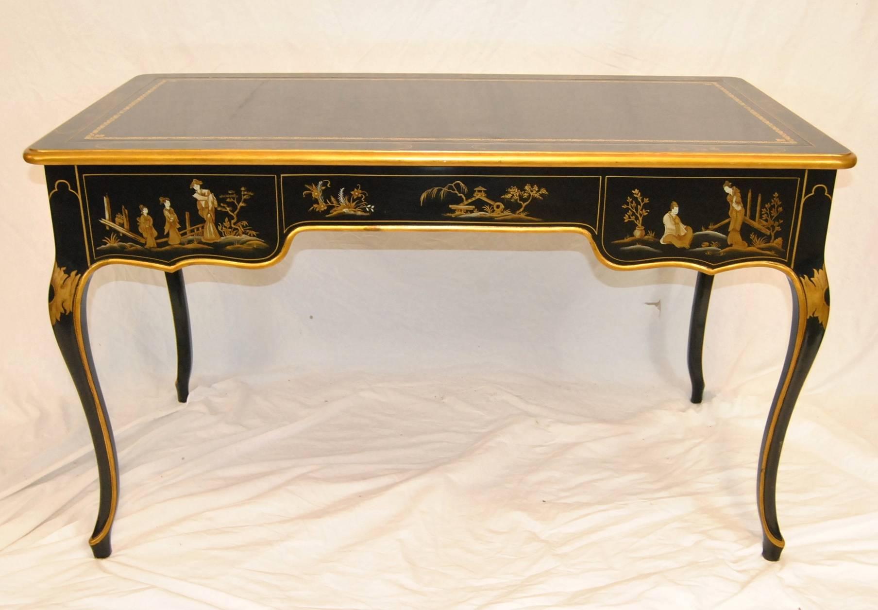 A stunning black lacquered chinoiserie writing desk by Baker Furniture. This desk is part of their Classic Collection. The desk is finished on all four sides for use centrally in your room. It features three dovetailed drawers with brass hardware.