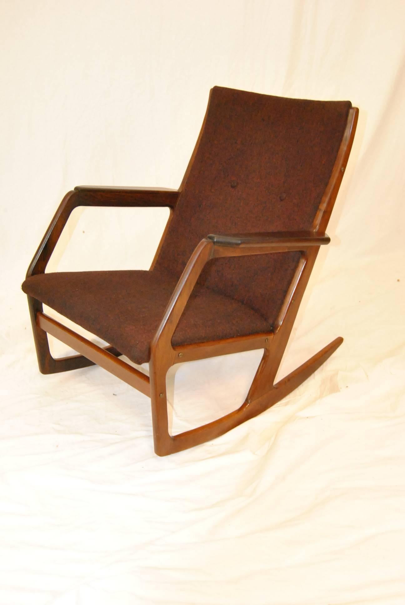 All original Kubus model 100 Rocker in rosewood. This iconic rocker was designed by Holger Georg Jensen and contains an invisible counter weight at front of seat which allows the design to be shorter than other rockers. Upholstery is original and is