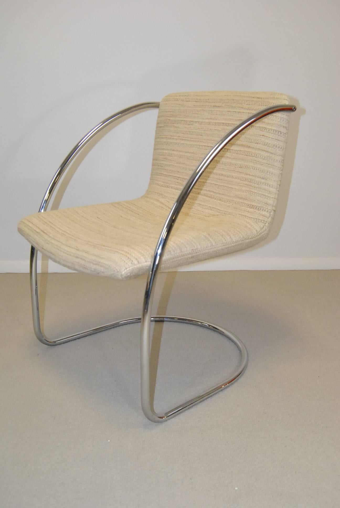 Classic set of Mid-Century design dining chairs by Milo Baughman. Each chair has a curved chrome frame which supports an upholstered back and seat. Upholstery is a heavyweight fabric with minimum wear and some imperfections. Very solid chairs,