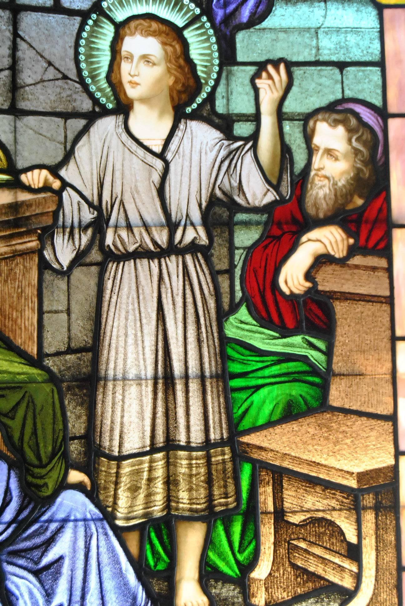A stunning hand-painted stained glass window from an American church. It depicts a young Jesus teaching in the temple. It features brilliant colors with Jesus and three elders. Very good condition with 2 breaks as photo'd. The dimensions are 46