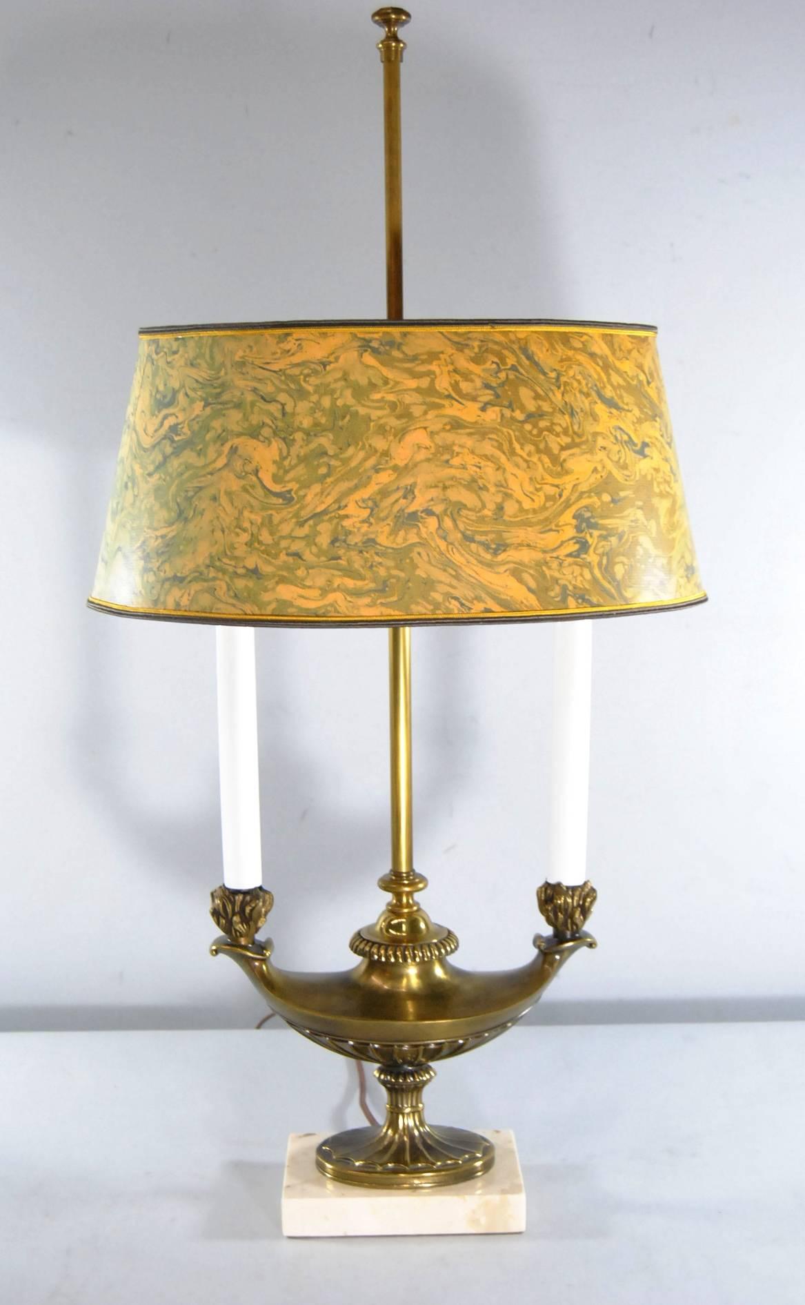 A great bouillotte lamp by Stiffel. Lamp has two candle lights which protrude from a brass double Aladdin style genie lamp with a switch on the back. Lamp sits on a marble base. The original shade is in a marbleized gold and green with gold
