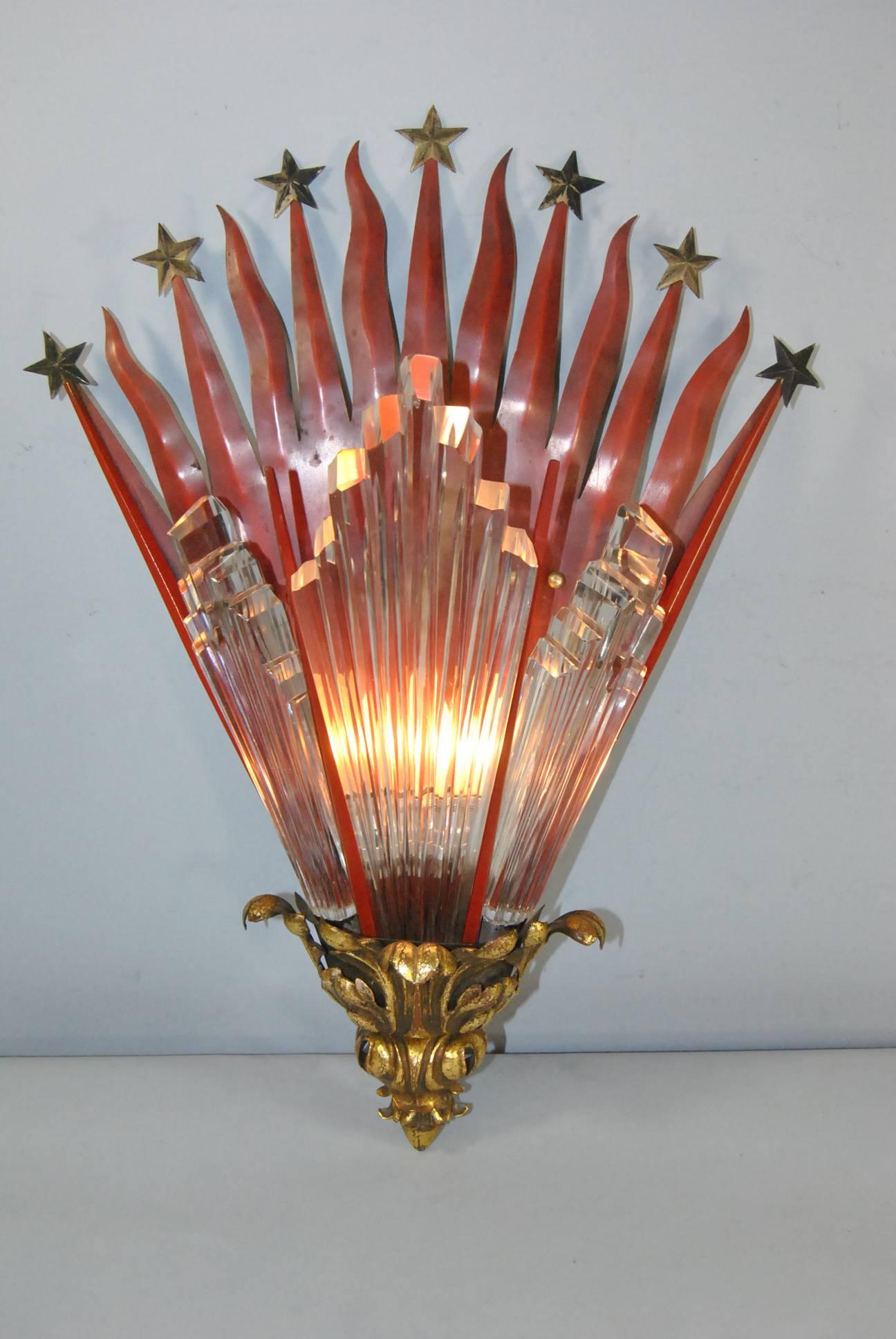 A unique Art Deco theatre wall sconce. It features original finish with a sun and stars motiff.  Three Lalique style glass panels that are 1 3/8" thick adorn the front.  Base is painted brass.