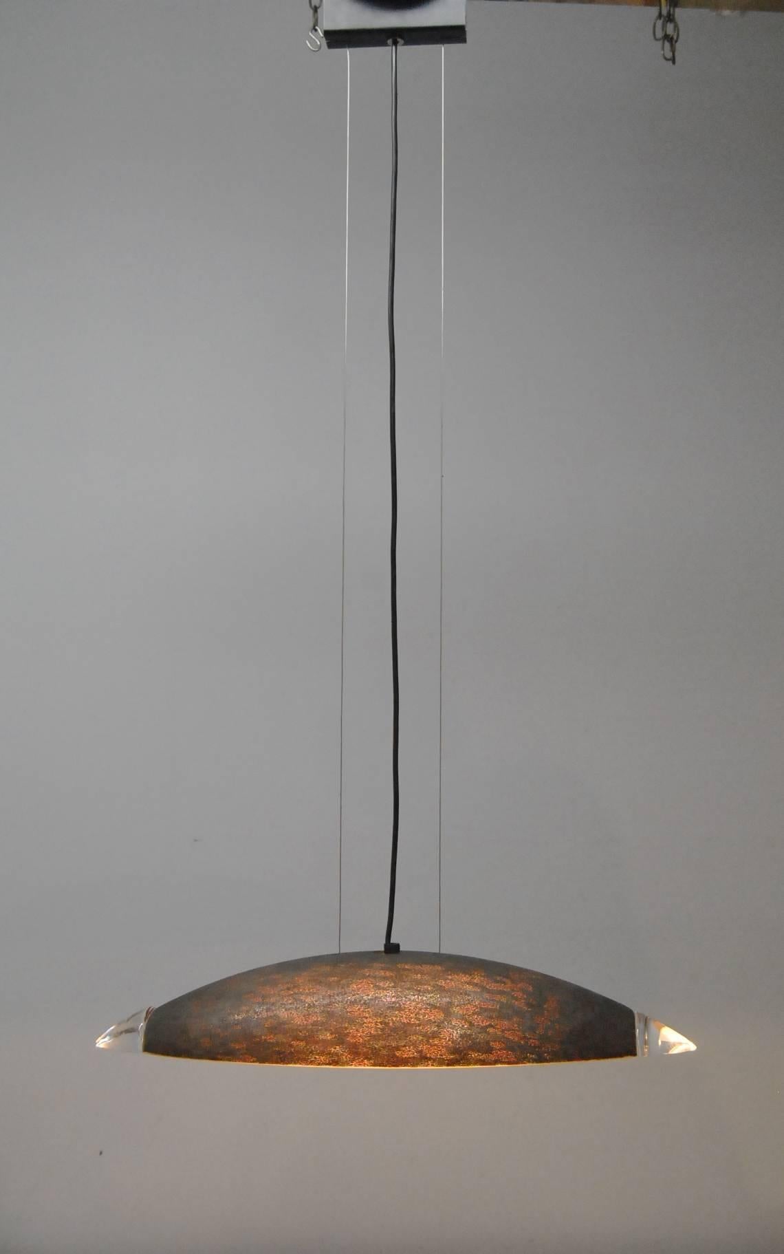 An unusual contemporary glass pendant light designed by Barovier e Toso for Murano. The shade is a mottled glass in a bronze tone with clear glass tips. It is suspended from the ceiling by two wires. The fixture is lit by three sockets. Just a great