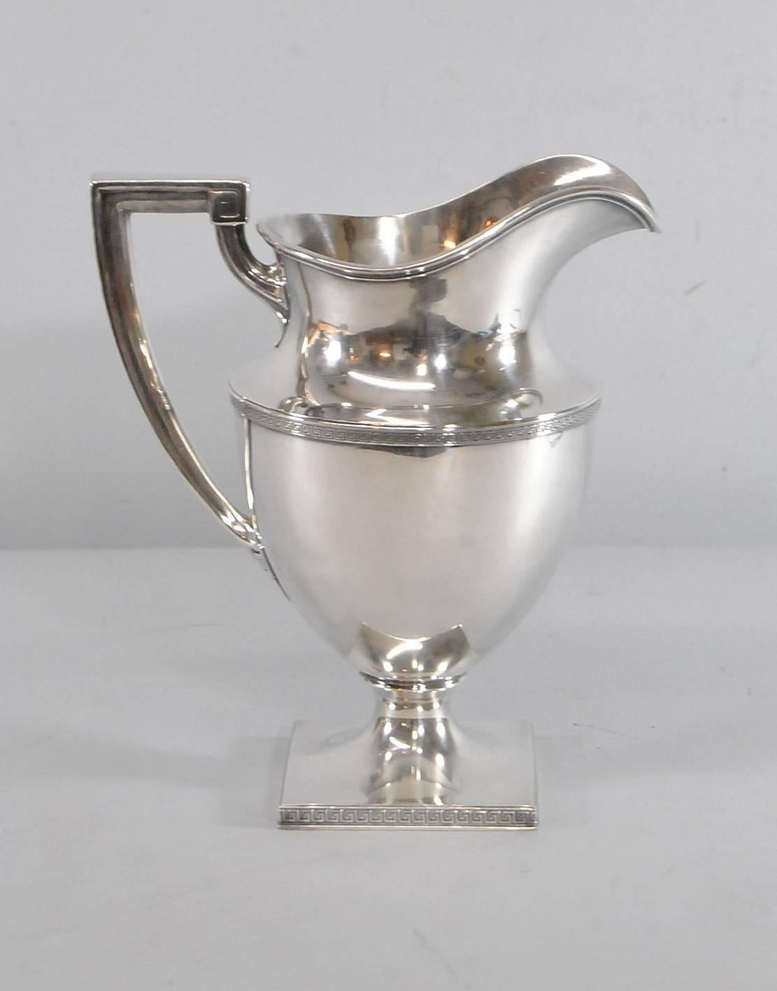 A great four pint water pitcher by Gorham in the Etruscan pattern. Great detailing with Roman key trim at base and middle of body. Roman key accents the handle. An elegant piece that is 10" tall and weighs 997.5 grams.
