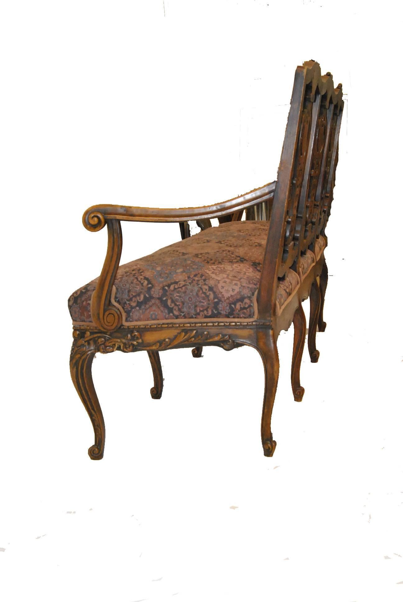 An exquisite French Chippendale bench/settee. Constructed in a richly carved pearwood featuring a fine Persian style fabric, a triple back with opened work design and curved arms and cariole legs. The dimensions are 58"W x 23"D x