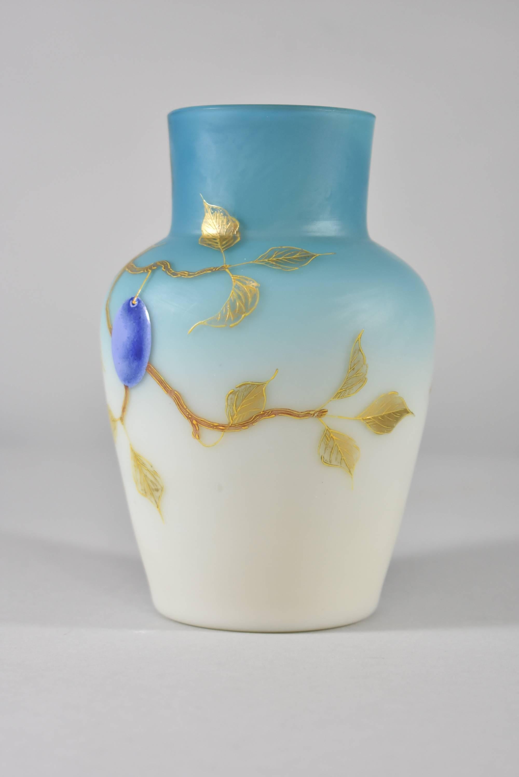 A beautiful pair of vases by Thomas Webb. These hand-painted vases features plumbs, foliage and branches against a soft blue/white satin background. They are marked on the bottom 676/7, W124 & 5. They are 6" T x 4" in diameter that