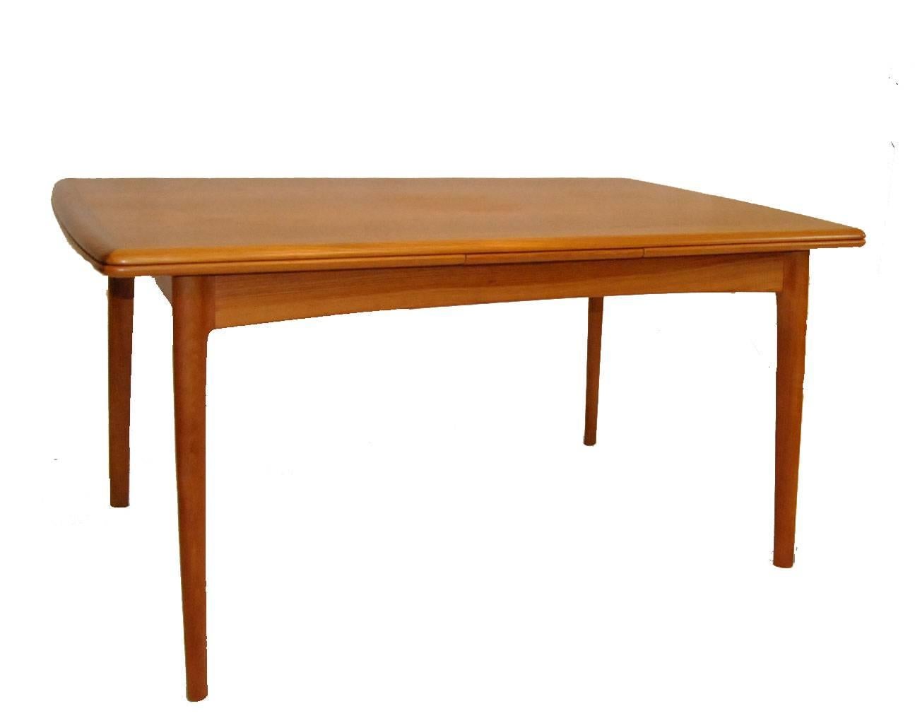 A beautiful Danish Modern teak dining table and chairs by Hornslet Kofoed. The set includes a refractory table and six "Liz" chairs by Hornslet Kofoed (two arms and four side chairs). The refractory table is 36" wide by 57" long