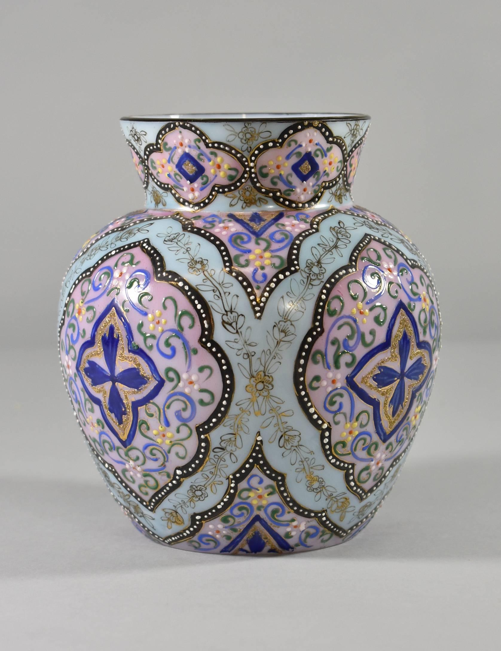 A beautiful art glass web in the Moroccan pattern by Webb. Measures: Vase is 6.5" tall and 3.25" in diameter. An aqua and rose background is accented with gold blue, black and green enamel work. Signed on the base.