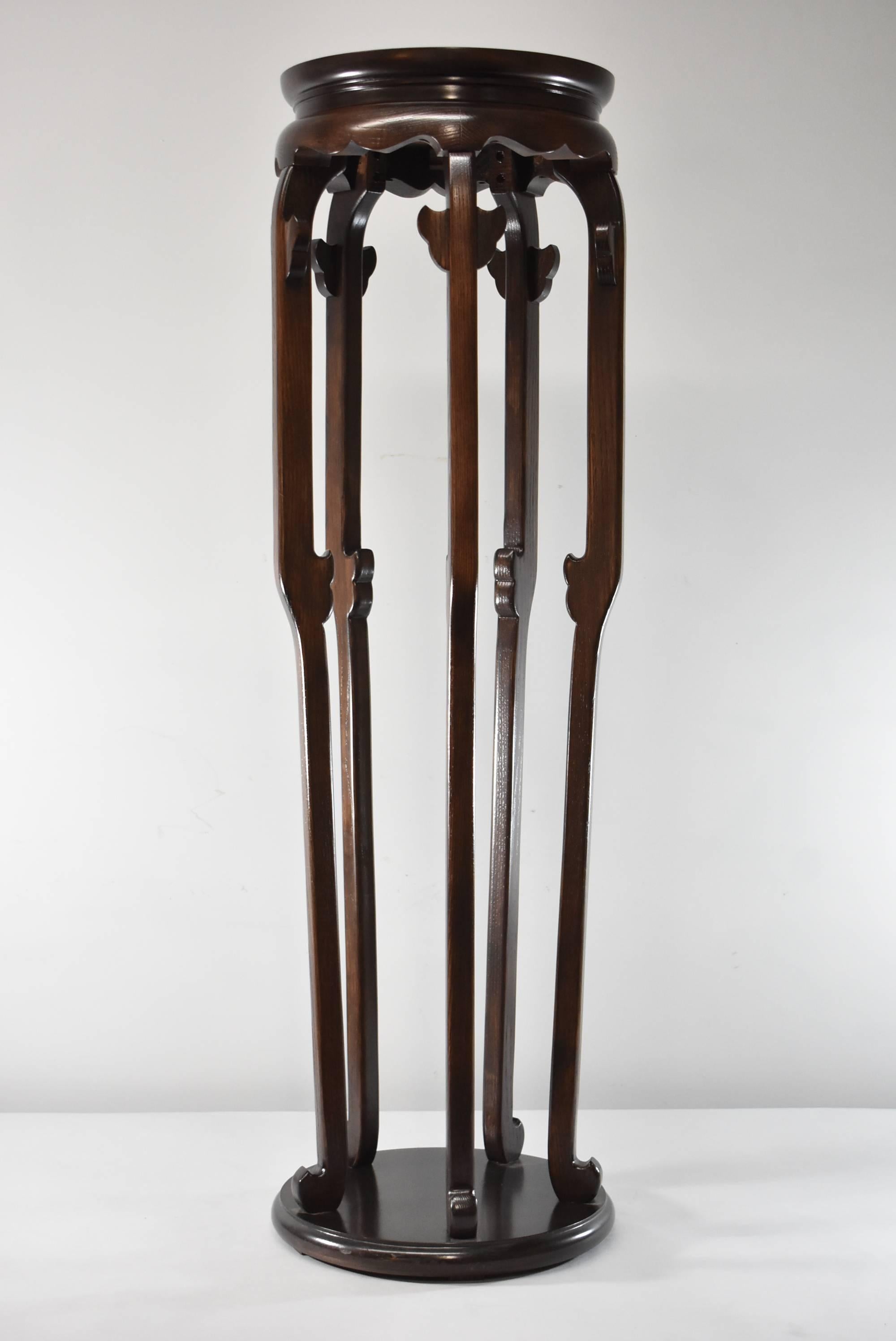 A beautiful pair of asian style burl wood stands designed by Michael Taylor for Baker Furniture. Each stand has five legs with carved accent at the top of each leg and scroll feet. Baker tag is on the base. Each stand is 42.75" tall by 13"