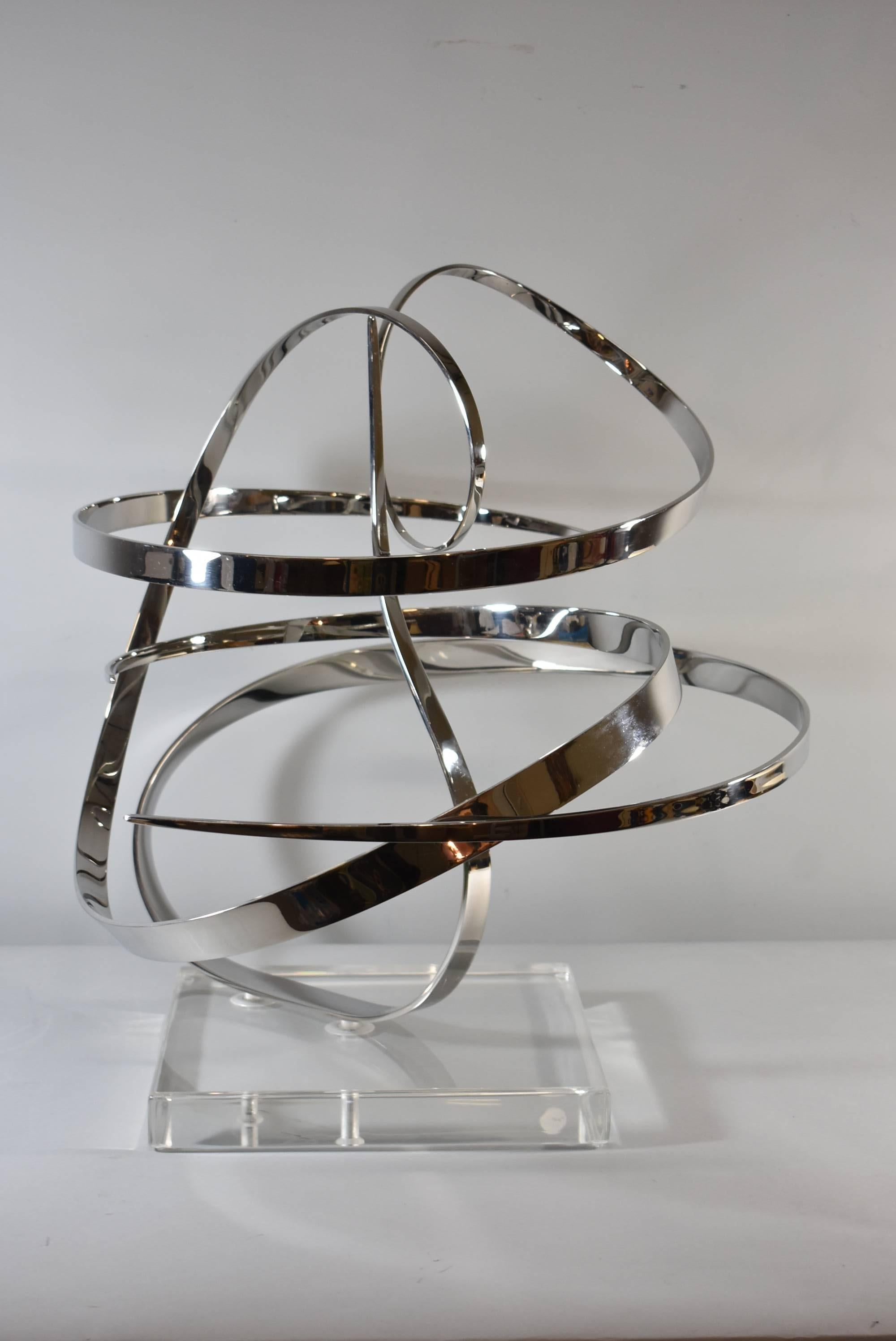 A fantastic modern Kinetic sculpture by George Beckman titled "Counterpoint". This polished stainless steel piece sits upon a Lucite base. George Beckman is an American Artist who over the last 3 decades has created many unique sculptures.