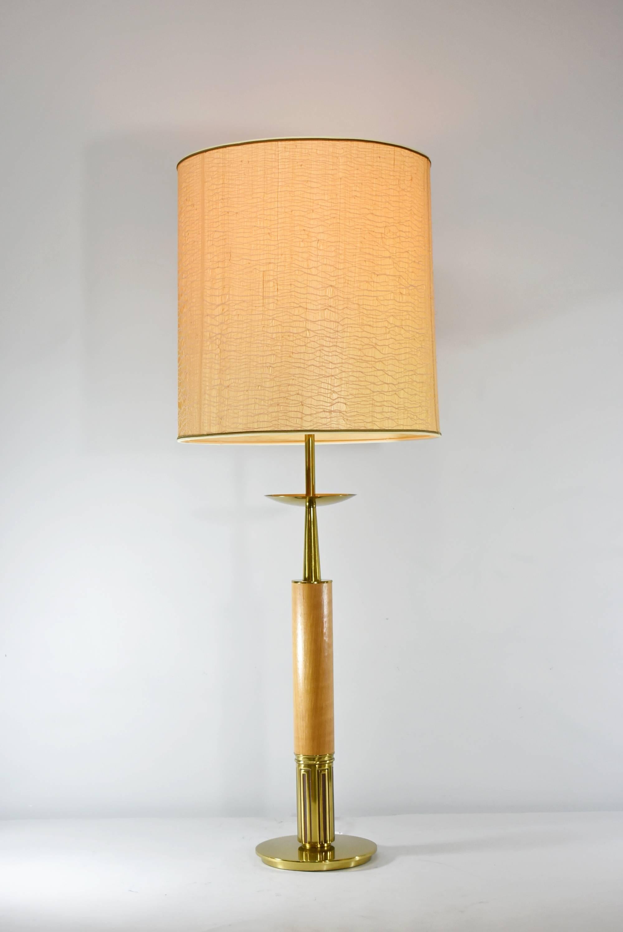 Walnut and brass table lamp by Stiffel designer Tommi Parzinger, circa 1970s. Three way single socket. Switch on cord and on lamp base. Very nice pre owned wear. Original grass cloth shade.