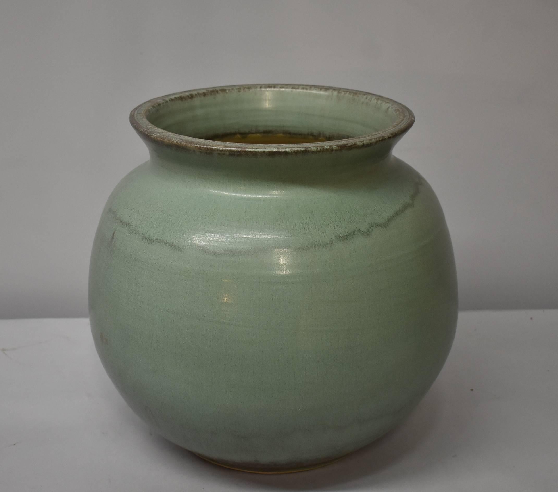 A large-scale vase by Pewabic Pottery of Detroit, MI and is done in a light jade green glaze. Marked on the bottom with impressed Pewabic Pottery and the year 2012. Very good condition, no chips or cracks noted. Dimensions: 14