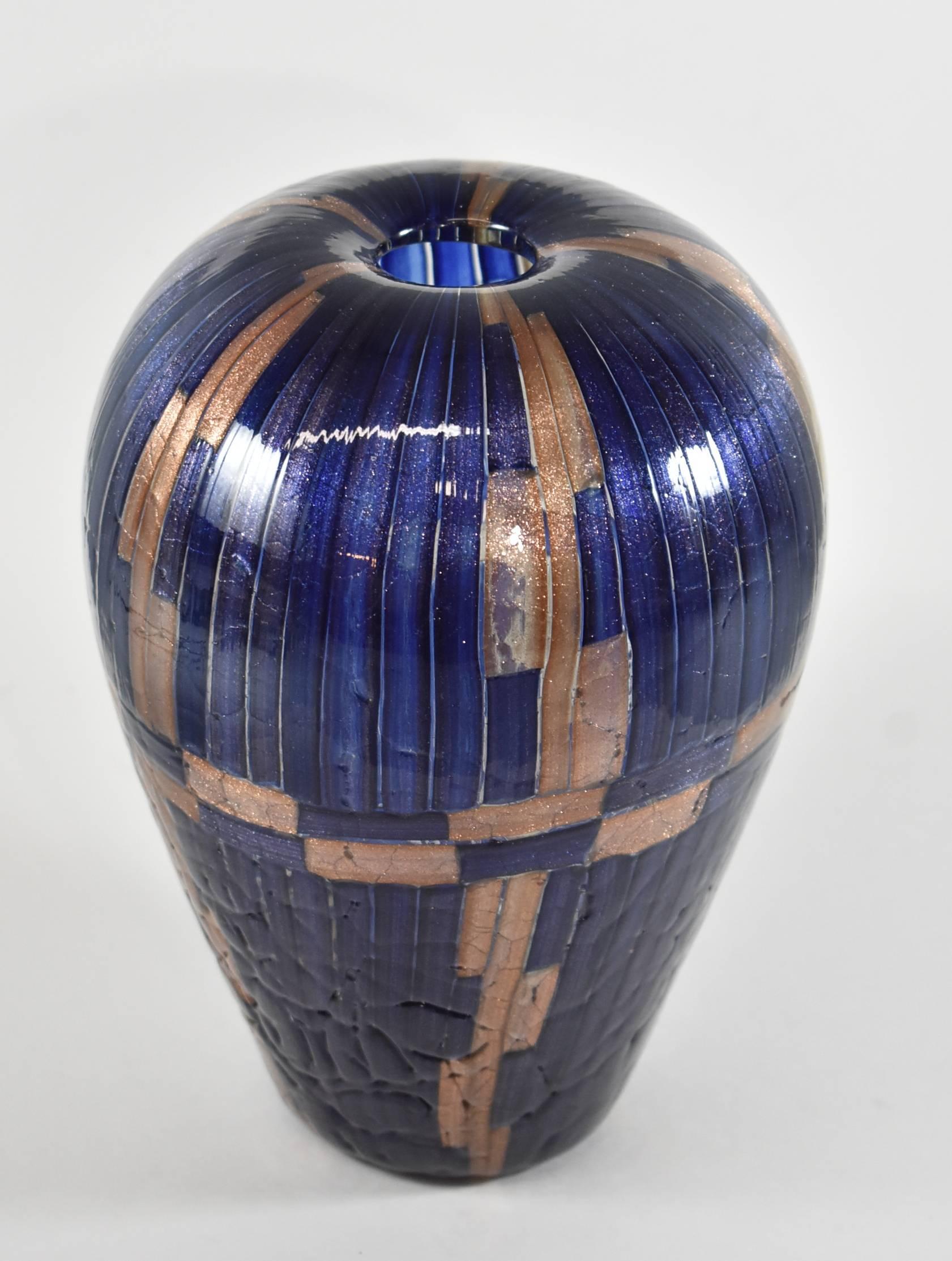 A beautiful cobalt blue vase with gold accents by Massimo Nordio. Massimo Nordio was born in Venice in 1947. He worked for Murano in 1980 while launching his own studio. He has pieces on permanent display at the Museo Vetrario Murano, the corning