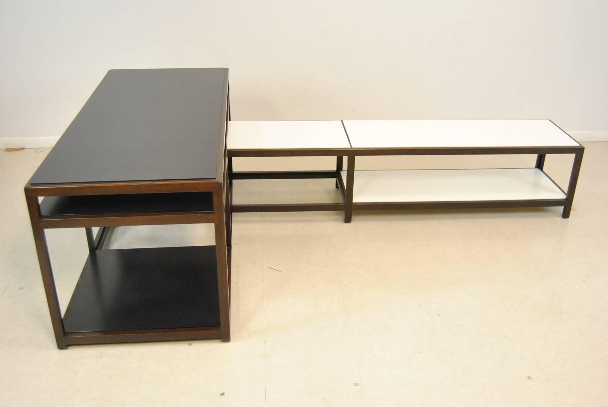 A fantastic set of interlocking tables by Edward Wormley for Dunbar Furniture. This great design allows you to arrange them together or separately in many different configurations. They have the Dunbar label on them. They also have the original