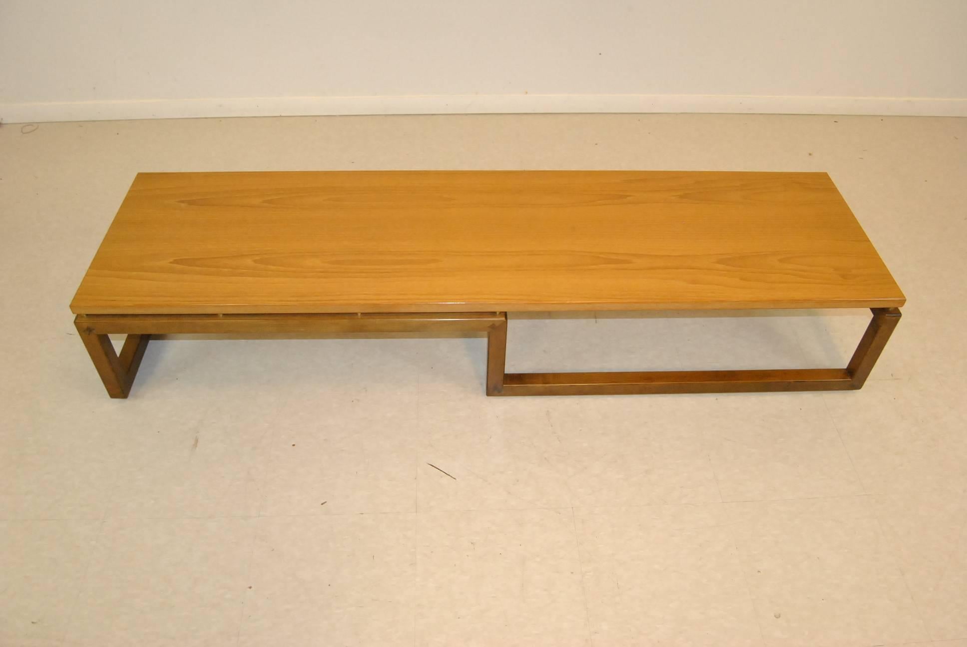 A great modern teak coffee table/bench by Michael Taylor for Baker Furniture. This table features an original finish, a floating top, straight lines with an inverted base. This great design is sure to add style to any room in your home. Very good