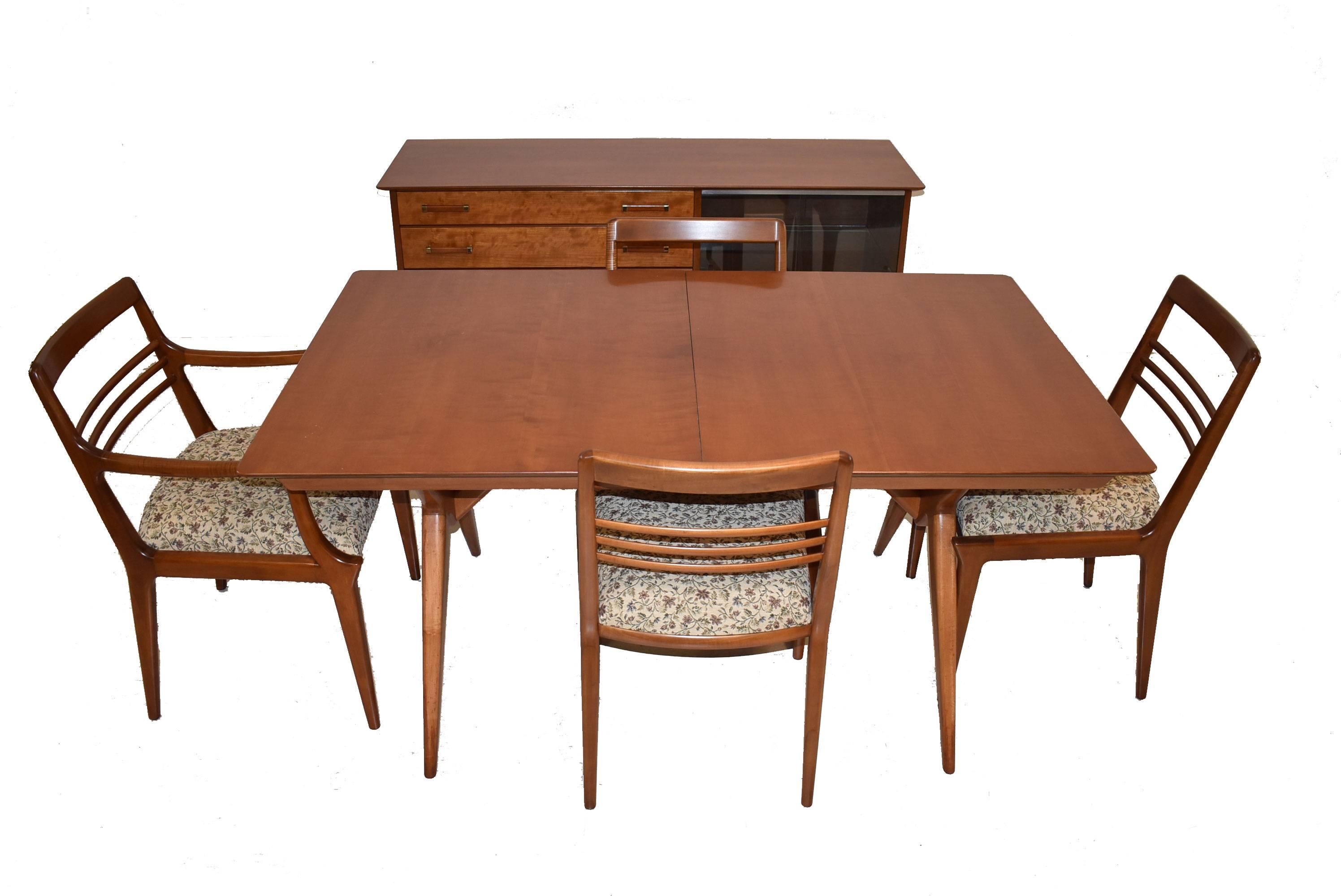 A fantastic Mid-Century dining room table and chairs by Johnson Furniture Co. This beautiful cherry set features great lines and a stylish modern design. It is in great condition and has been refinished. There are 3 - 11