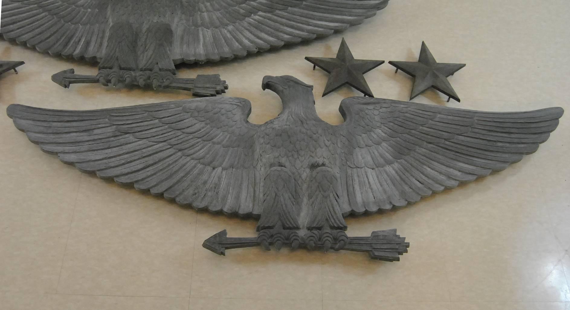 A unique pair of bronze building eagles with two pairs of stars. The bronze eagles and stars have a wonderful Verdigris patina and great detailing. The wing span on the eagles is 5 foot wide and each is 21