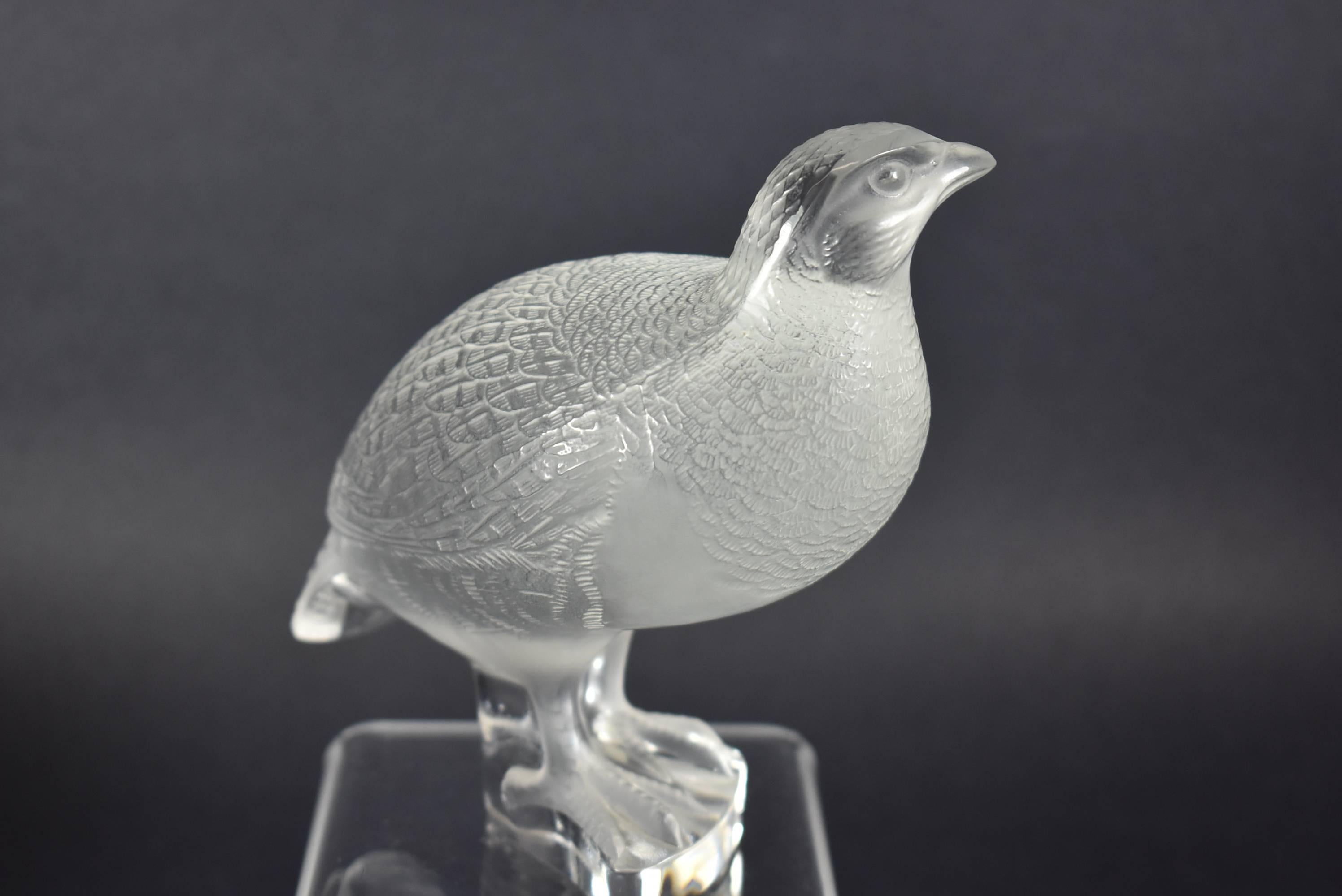 A beautiful pair of Lalique France Frosted Partridge or Quail Figurines. Signed with the Lalique label. One bird is standing and called, 