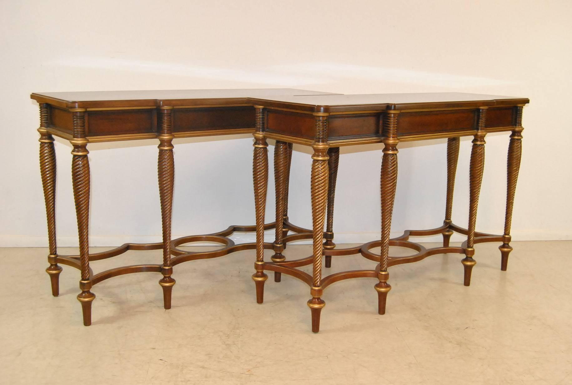 A stunning pair of console tables by Mario Buatta for Widdicomb Furniture. They feature a distressed finish, gold trim painted with six swirl carved legs that are attached by a shaped stretcher. Great condition, these tables are sturdy and elegant,