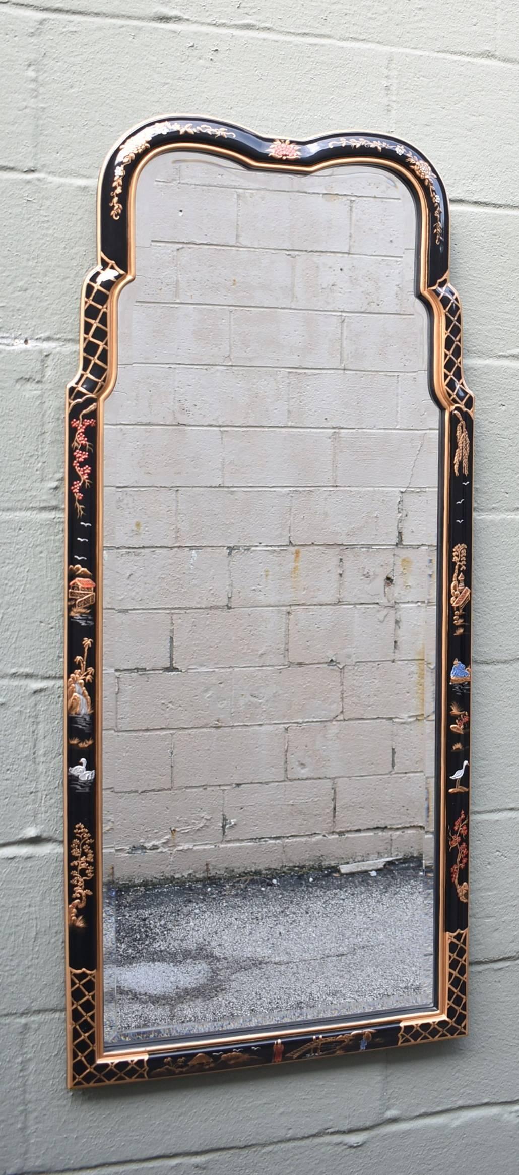 A beautiful set of black handpainted chinoiserie beveled glass mirrors by Henredon.  The mirrors each have hand painted frames in bright colors of blue, red, and gold on black and are signed.  One is signed Vicky 88 and on is signed DH 90.  Each