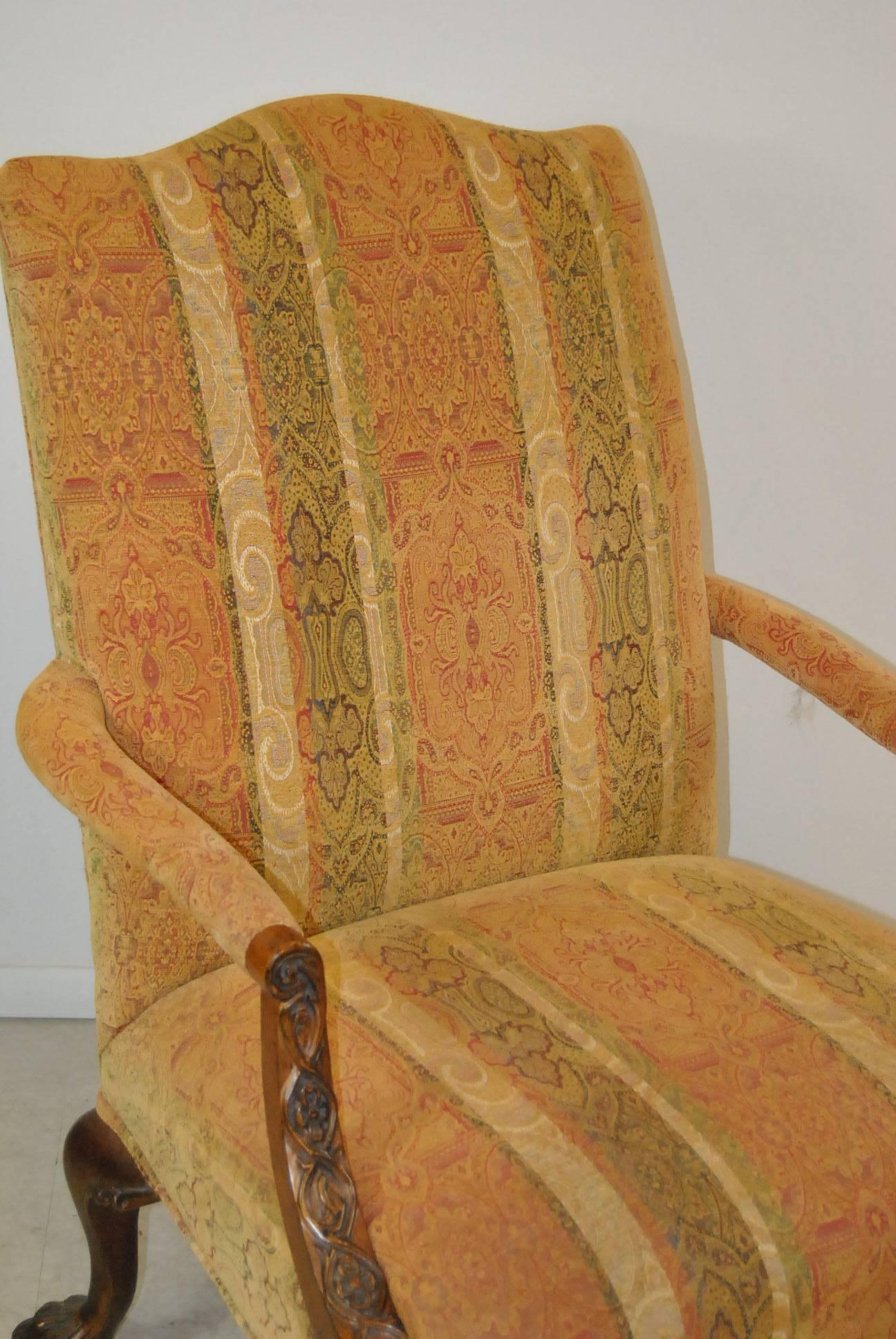 A beautiful mahogany Fauteuil armchair by Henredon. This is part of their Natchez collection. Features include carved detailing on arms and heavily carved claw feet. Chair is upholstered in a muted print with stripes in earth tones of green, tan and