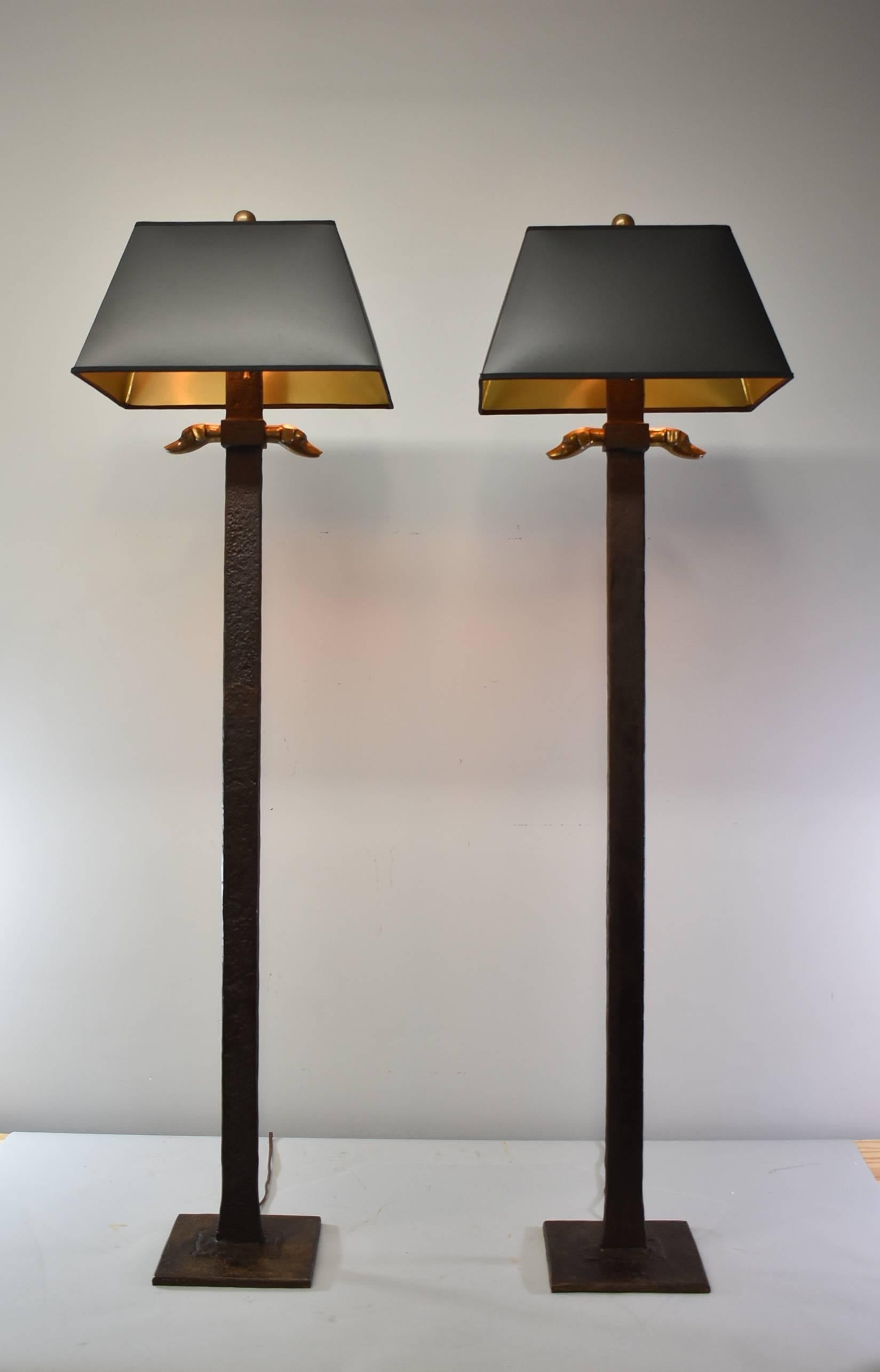 An unusual pair of iron floor lamps by Chapman. Measure: Each lamp is 54