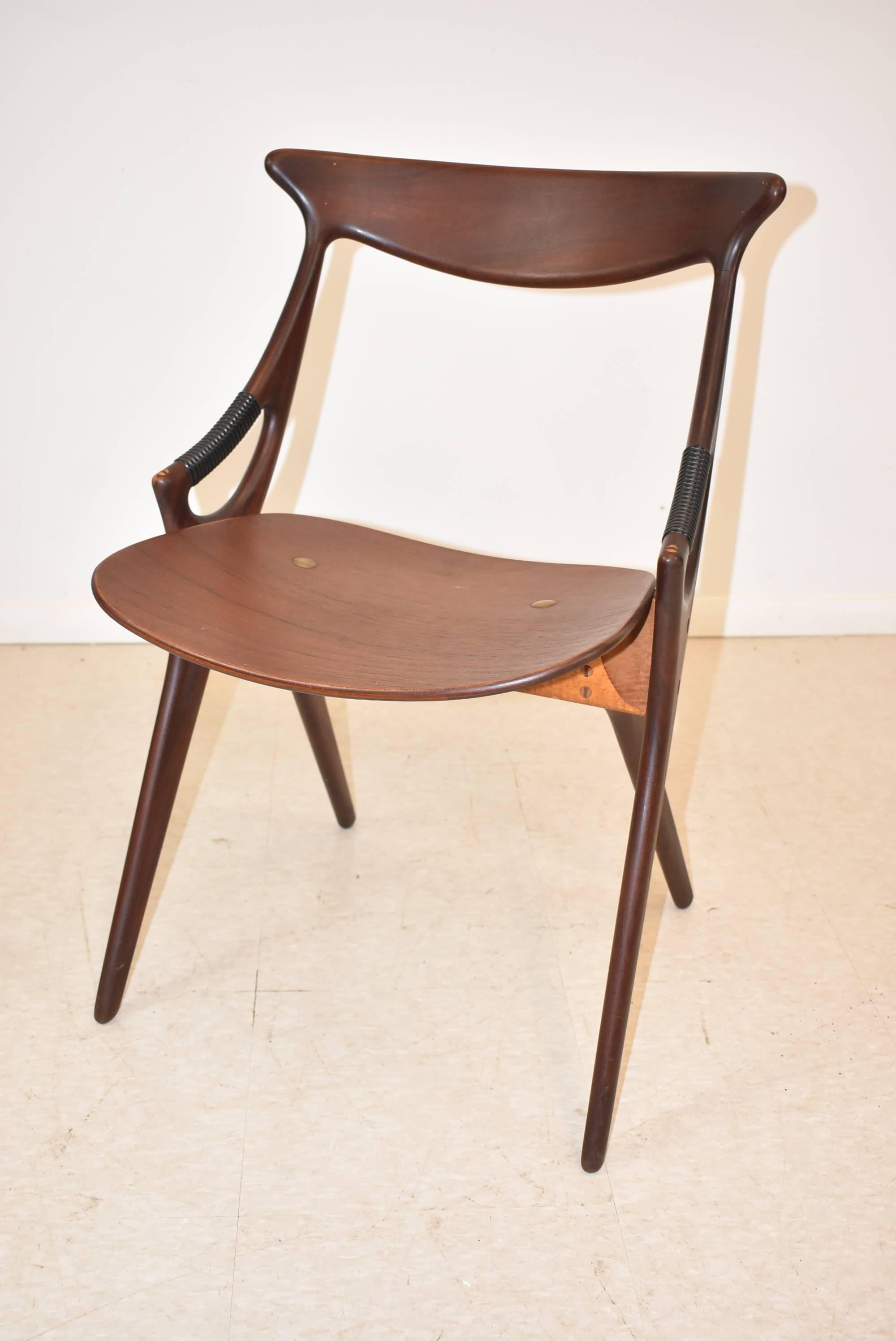 A park of Model 71 Chairs by Arne Hovmand Olendm, (Denmark 1919-1989) for Mogens Kold Mobelfabrik, circa 1950s. These chairs have a unique shape with the most amazing teak arms with wrapped arm supports and bent plywood seats. The chairs have subtle