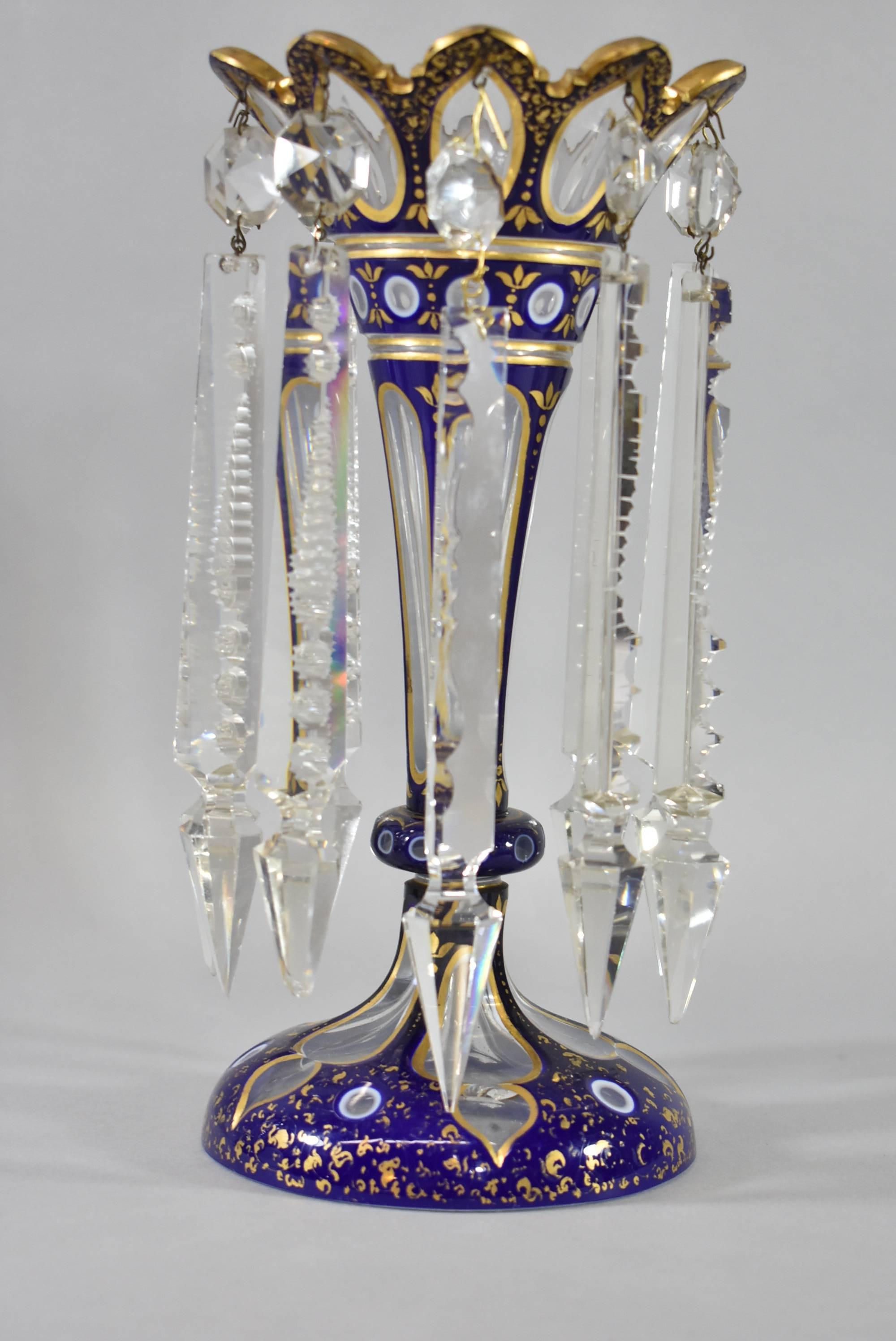 A stunning pair of Moser Bohemian style Lustre Vases. Hand-painted cobalt blue with gold and white trim and crystal prisms. The dimensions are 10