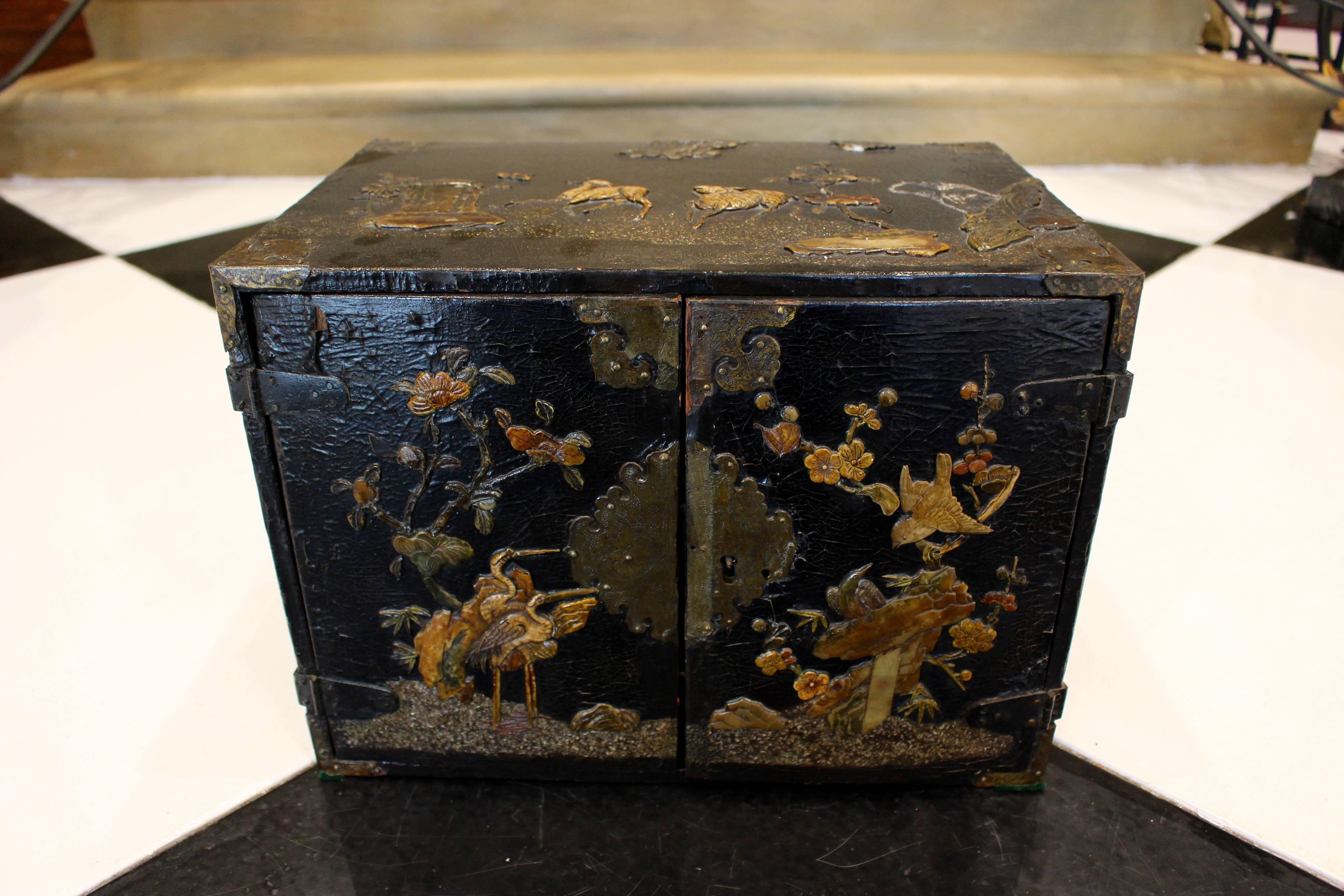 Gilt Small Chinese Black Lacquered Wood Cabinet with Raised Traditional Scenery For Sale